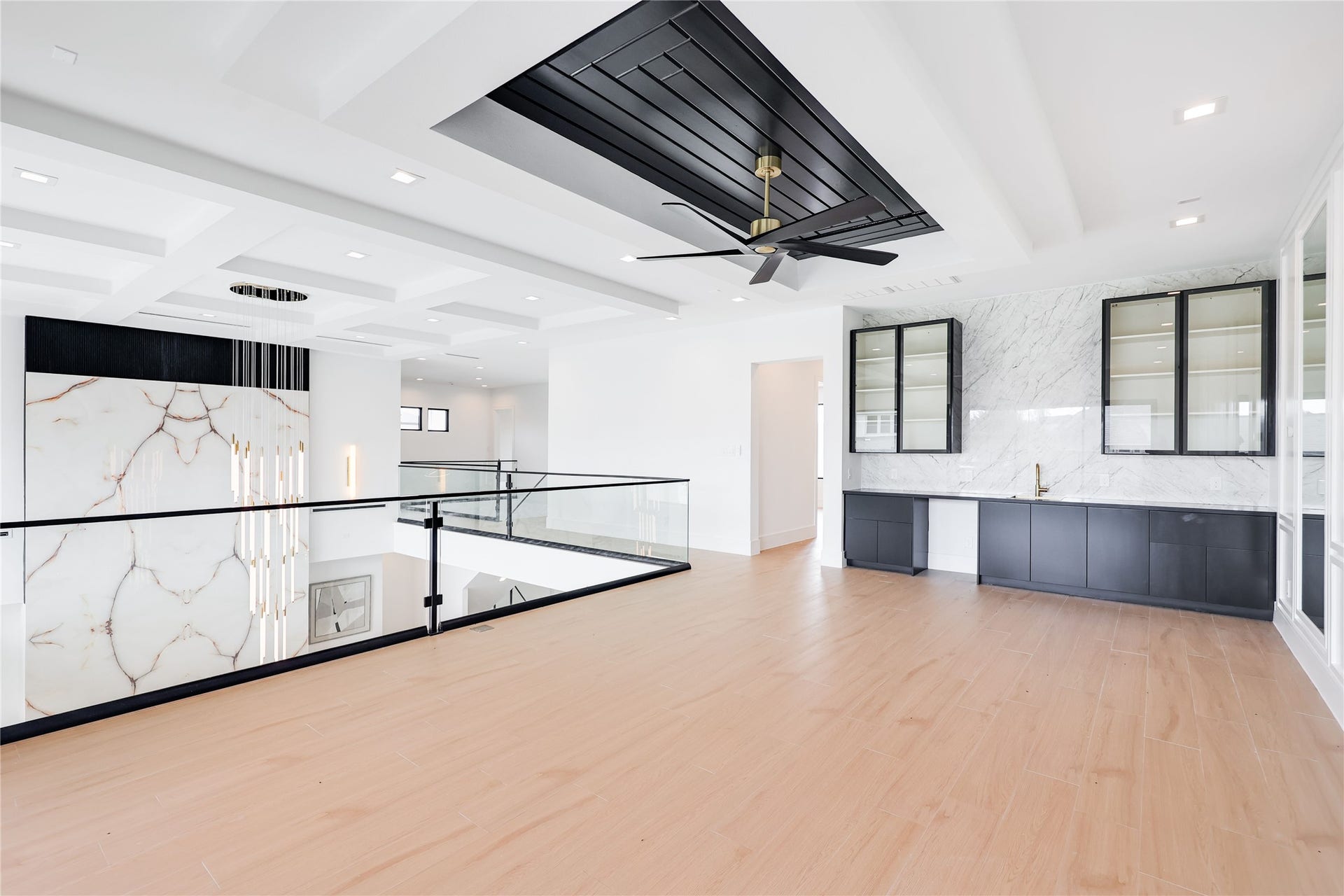 A beautifully versatile upstairs retreat, equally suited for a game room, secondary living area or gathering space. A convenient mini kitchen and ample storage along a second wall for effortless entertaining.