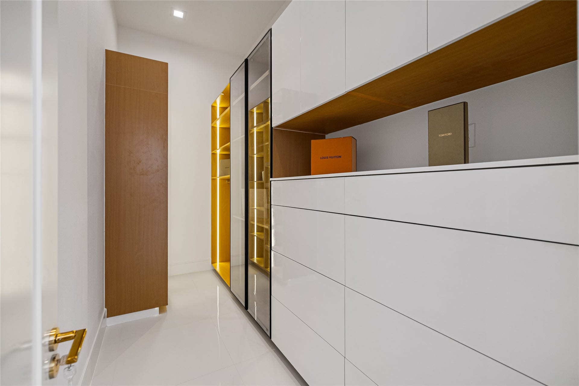 Step inside the second custom walk-in closet thoughtfully designed with abundant built-in drawers and enclosed hanging space.