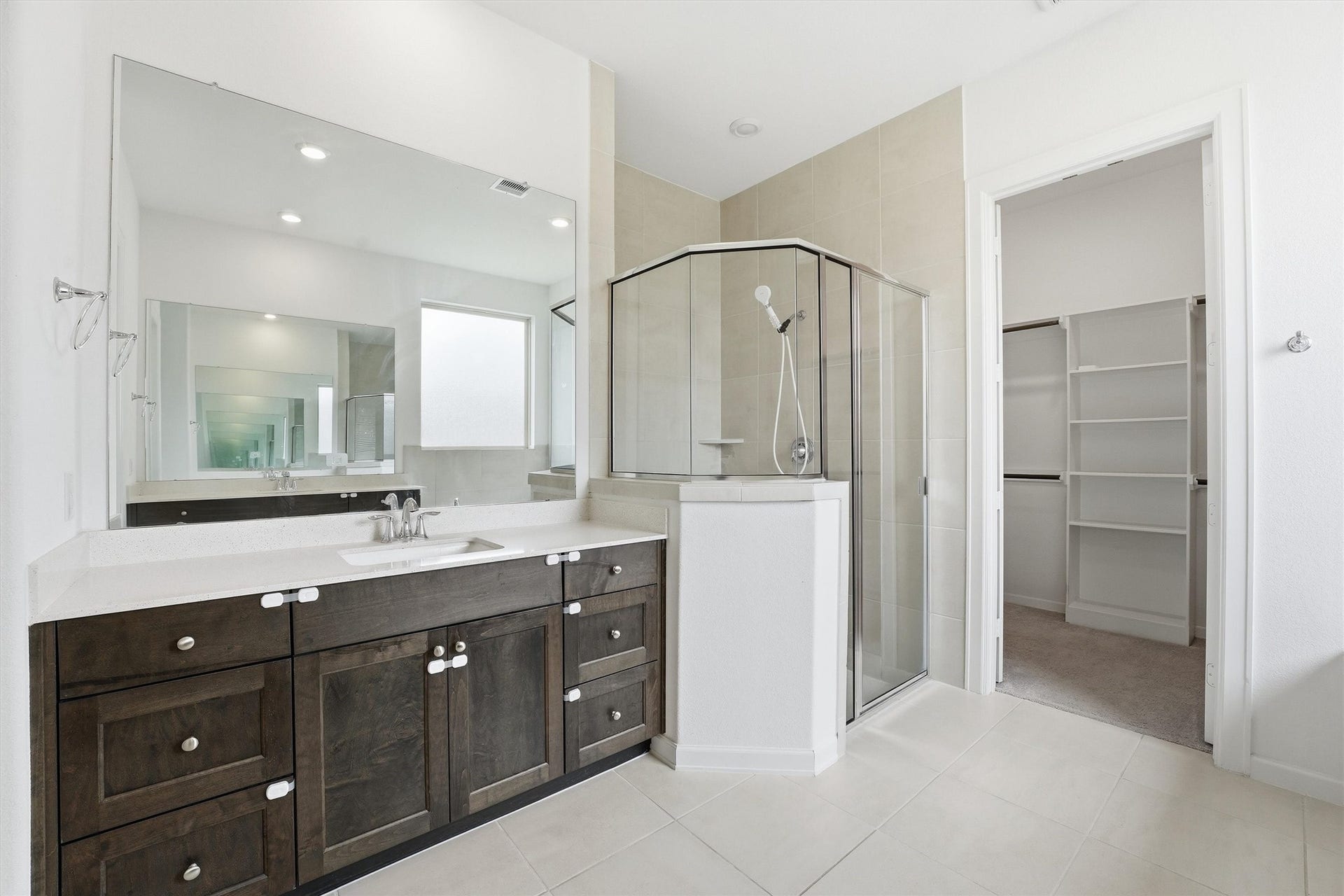 Spacious owner's bath with dual vanities, separate shower, soaking tub and walk in closet.