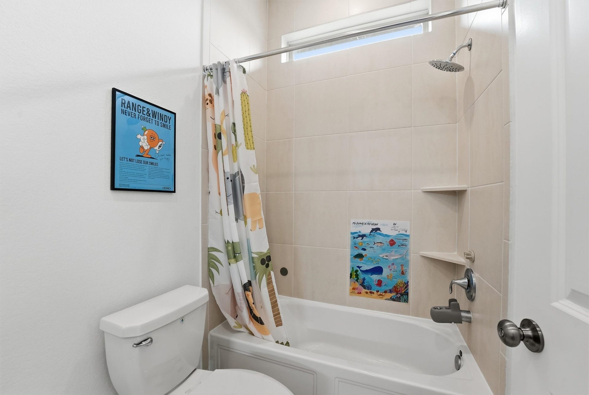 Bright and cheerful bathroom featuring a modern shower-tub combo and natural light from a high window.