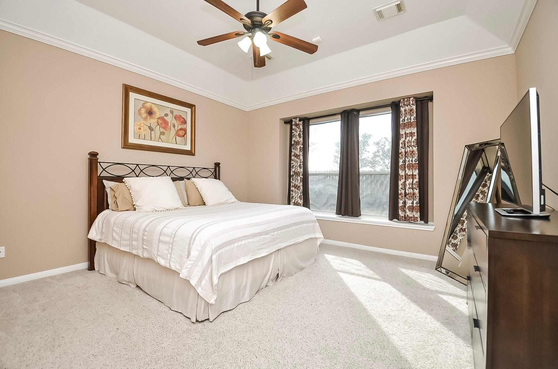 1727 Maryvale Drive, Katy, TX 77494 The primary suite boasts a charming window seat and elegant tray ceiling.
