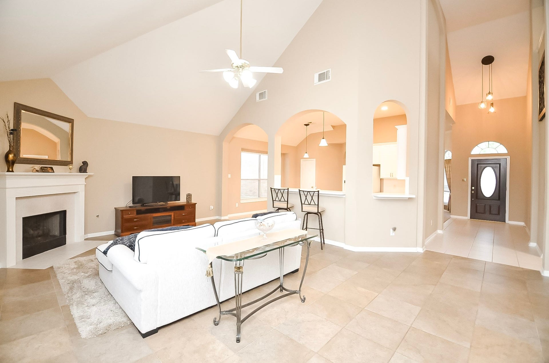 1727 Maryvale Drive, Katy, TX 77494 Vaulted ceiling and abundant natural light enhance the family room's inviting ambiance.