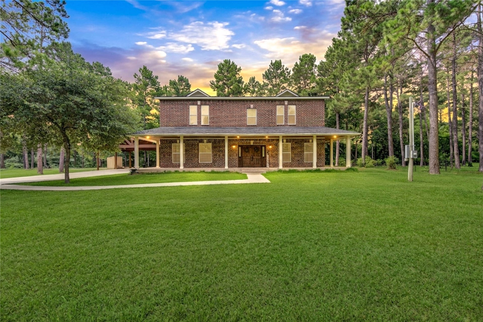 20531 Faye Street, Tomball, TX 77377 Set on 2.09 beautifully wooded acres, this stunning estate welcomes you with a grand wraparound porch, mature trees, and a serene park-like setting.