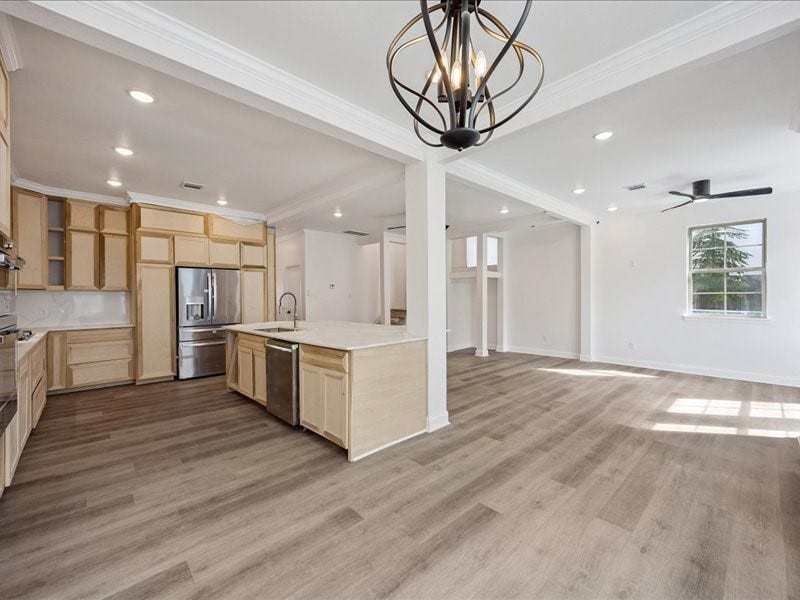 2123 Kingston Street, Houston, TX 77019 Kitchen & Living Area Expansive open layout with wide-plank flooring, recessed lighting, crown molding, and abundant natural light. Home is currently under renovation and not yet complete.
