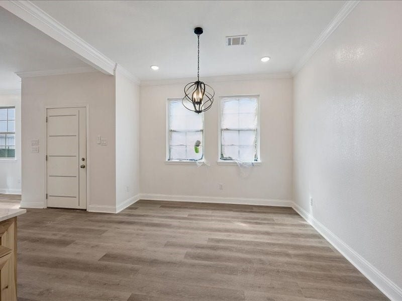 2123 Kingston Street, Houston, TX 77019 Dining Area Dedicated dining area positioned just off the kitchen with wide-plank flooring, crown molding, contemporary lighting, and natural light. Additional finishing touches remain in progress.