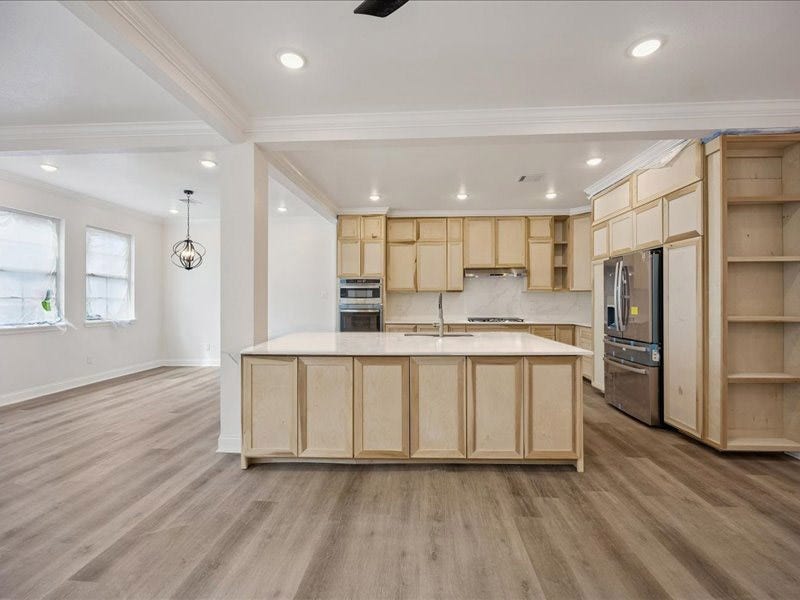 2123 Kingston Street, Houston, TX 77019 Kitchen Spacious kitchen taking shape with custom on-site-crafted cabinetry, generous counter space, stainless-steel appliances, gas cooking, and an oversized island. Cabinetry and finish work are still underway.