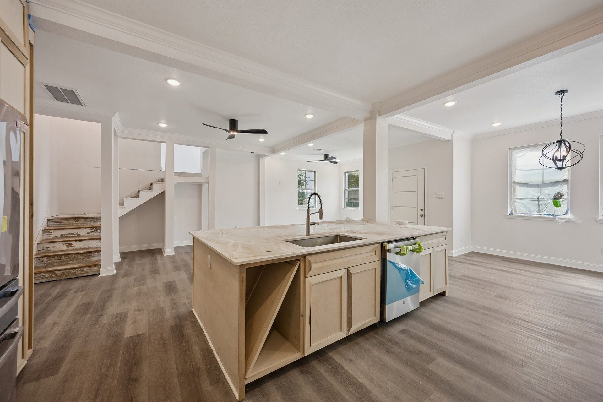 2123 Kingston Street, Houston, TX 77019 Oversized kitchen island overlooking the spacious living area and staircase, highlighting the homes open-concept design and seamless flow.