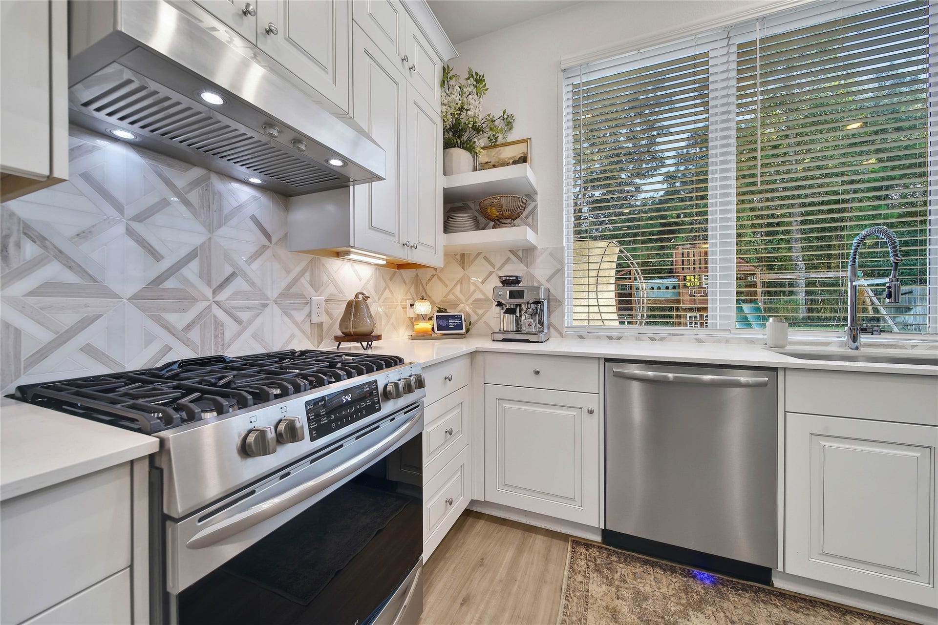 6048 Windward Falls Way, Porter, TX 77365 The open shelving and backsplash really give this kitchen personality! And that view is amazing! Cook and watch the kids at the same time.