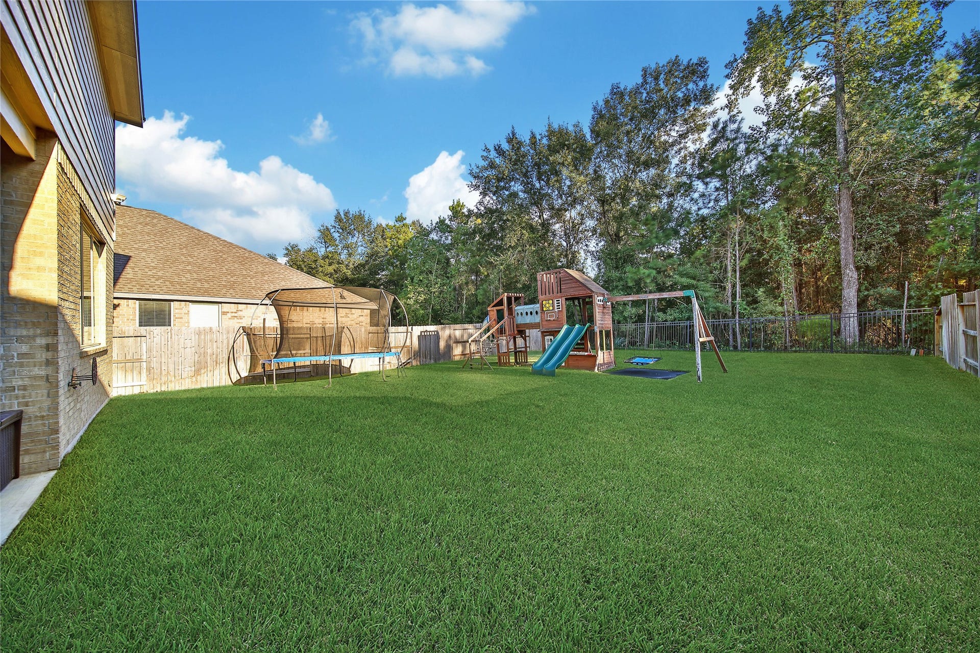 6048 Windward Falls Way, Porter, TX 77365 Back yard view. Sprinkler system throughout front and back yard.