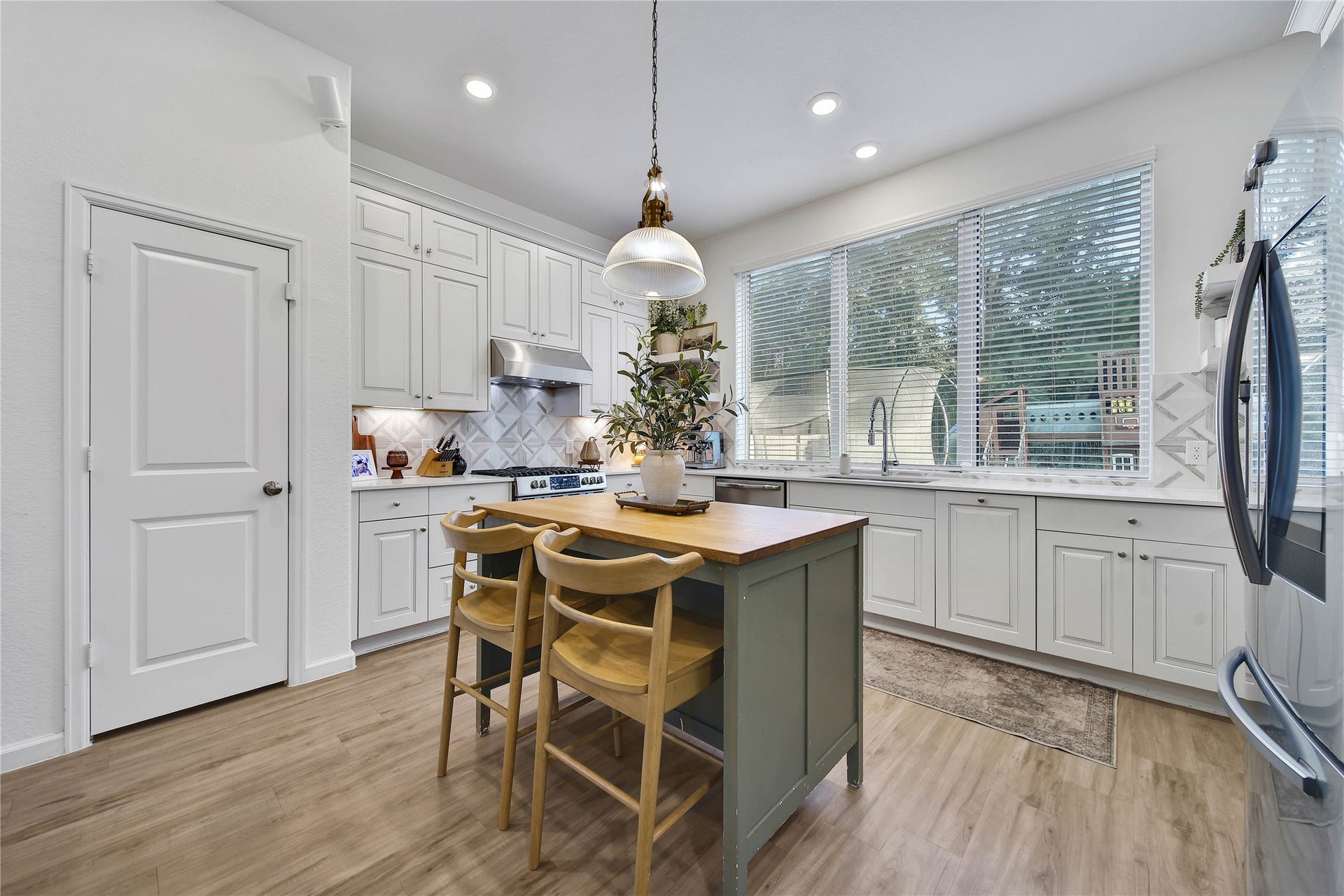6048 Windward Falls Way, Porter, TX 77365 Dishes with a view! Pantry on the left. Refrigerator with touch screen is included with the sale of the home.