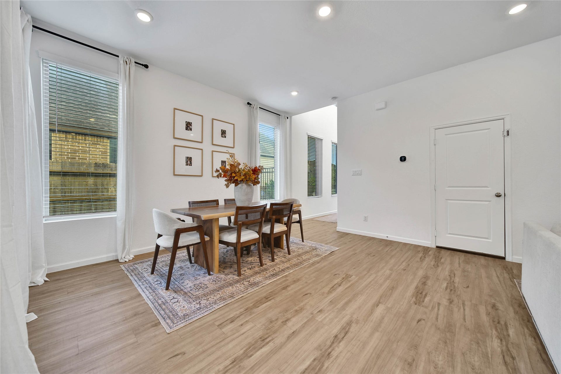 6048 Windward Falls Way, Porter, TX 77365 Beautiful dining area and definitely space for a larger table if you need it! The curtains and rods stay with the home.