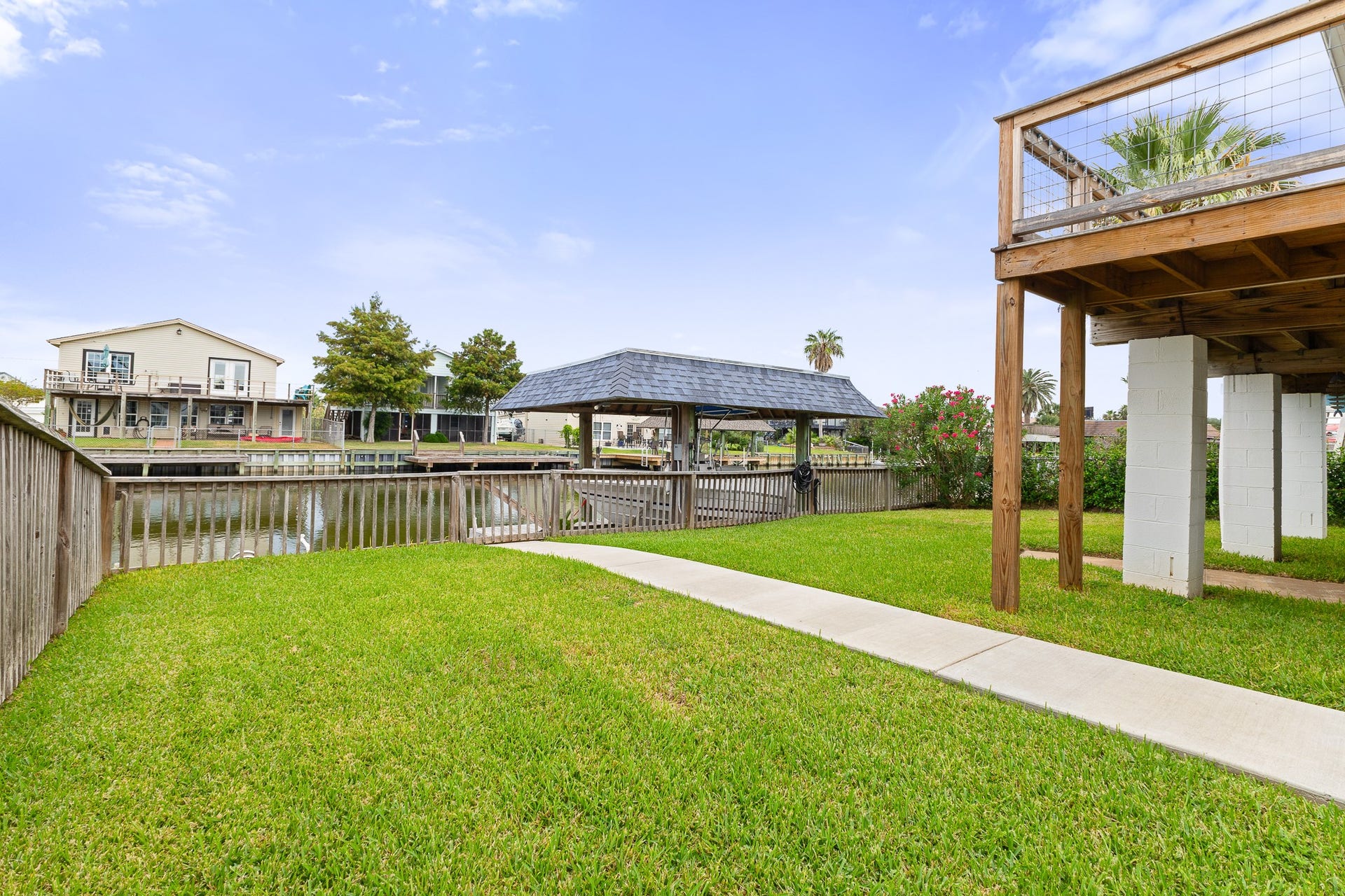 66 Tarpon Street, Bayou Vista, TX 77563 Spacious fenced canal-front yard