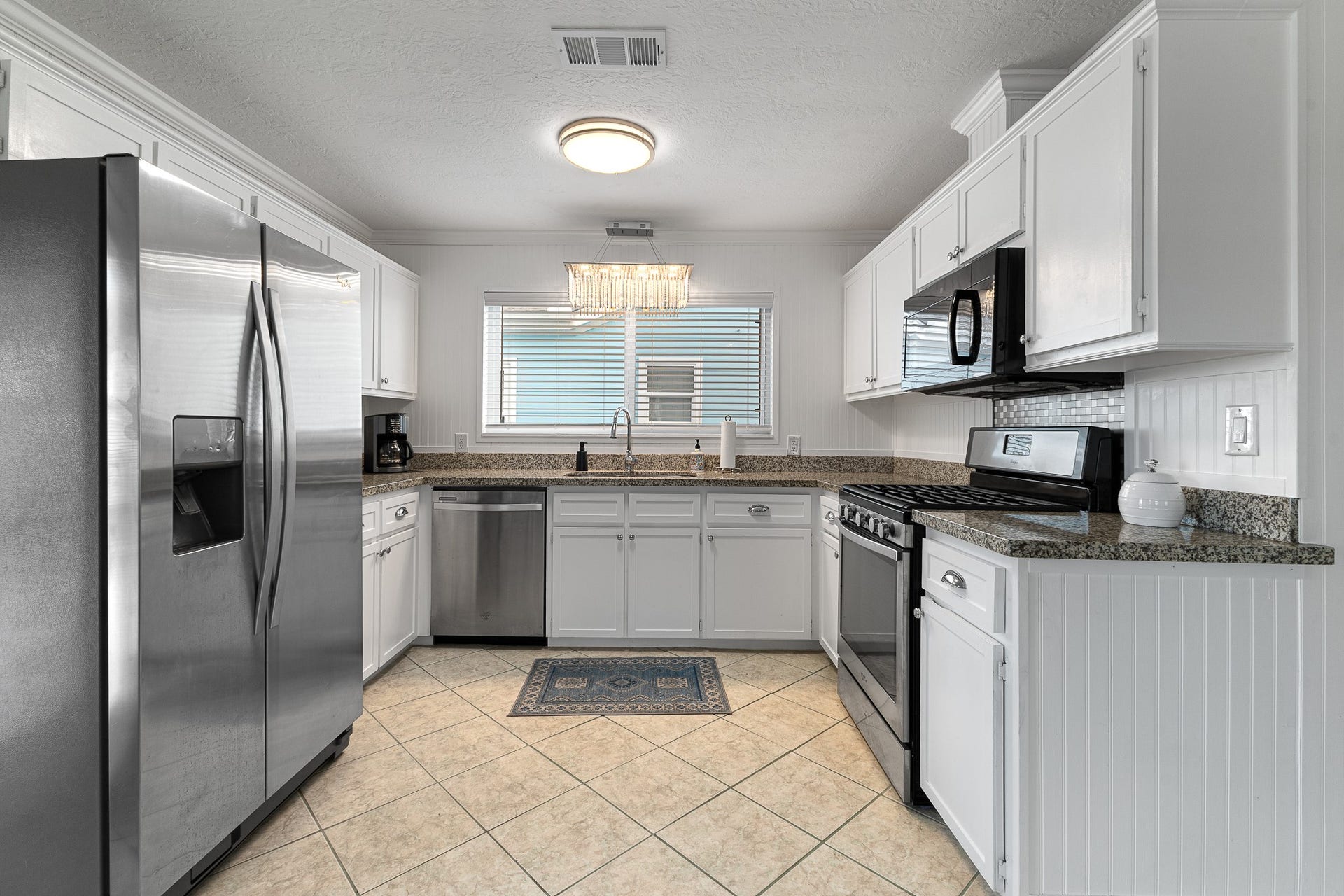 66 Tarpon Street, Bayou Vista, TX 77563 Bright kitchen with white cabinetry, granite countertops and stainless appliances.