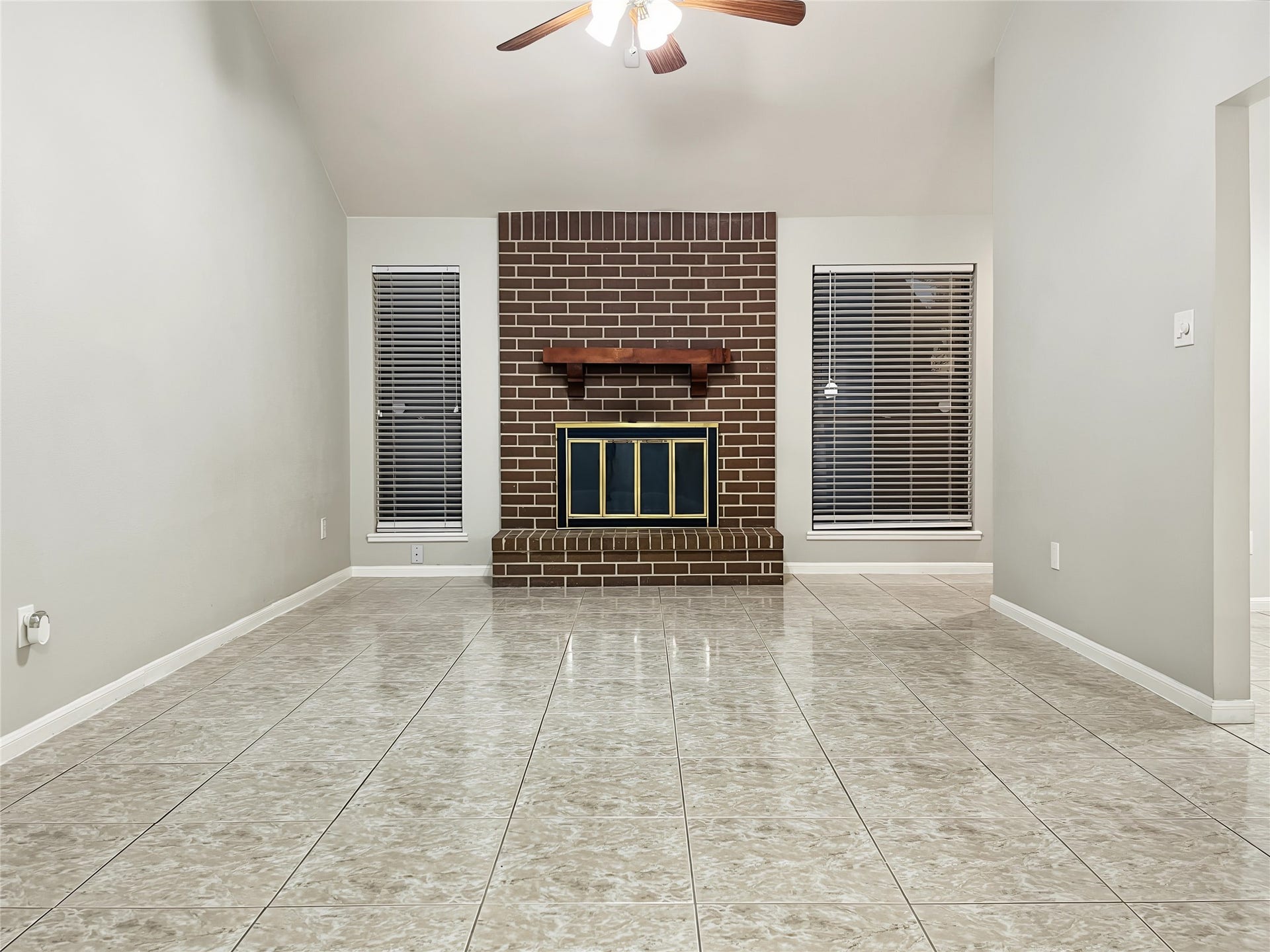 Great view of the spacious living room area and the fireplace.