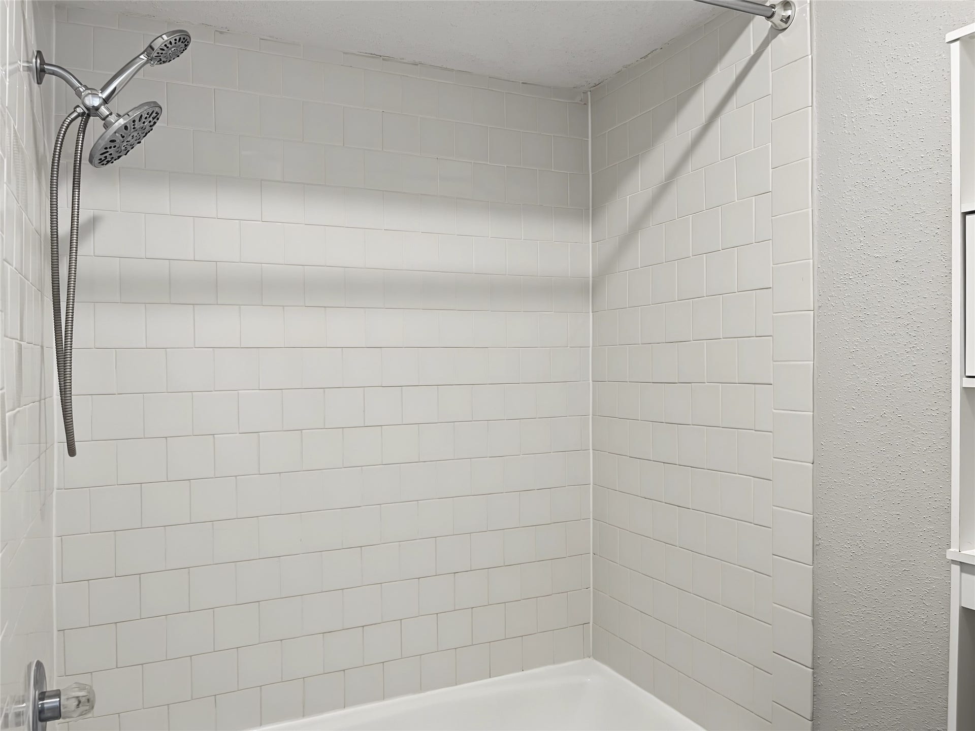 View of the tub/shower combo in the primary bathroom.