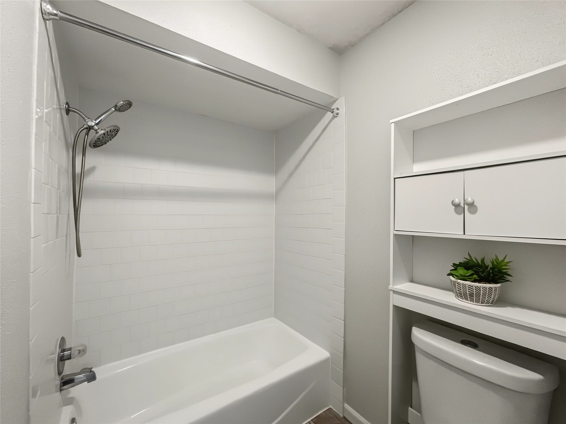 View of the tub/shower combo in the primary bathroom.