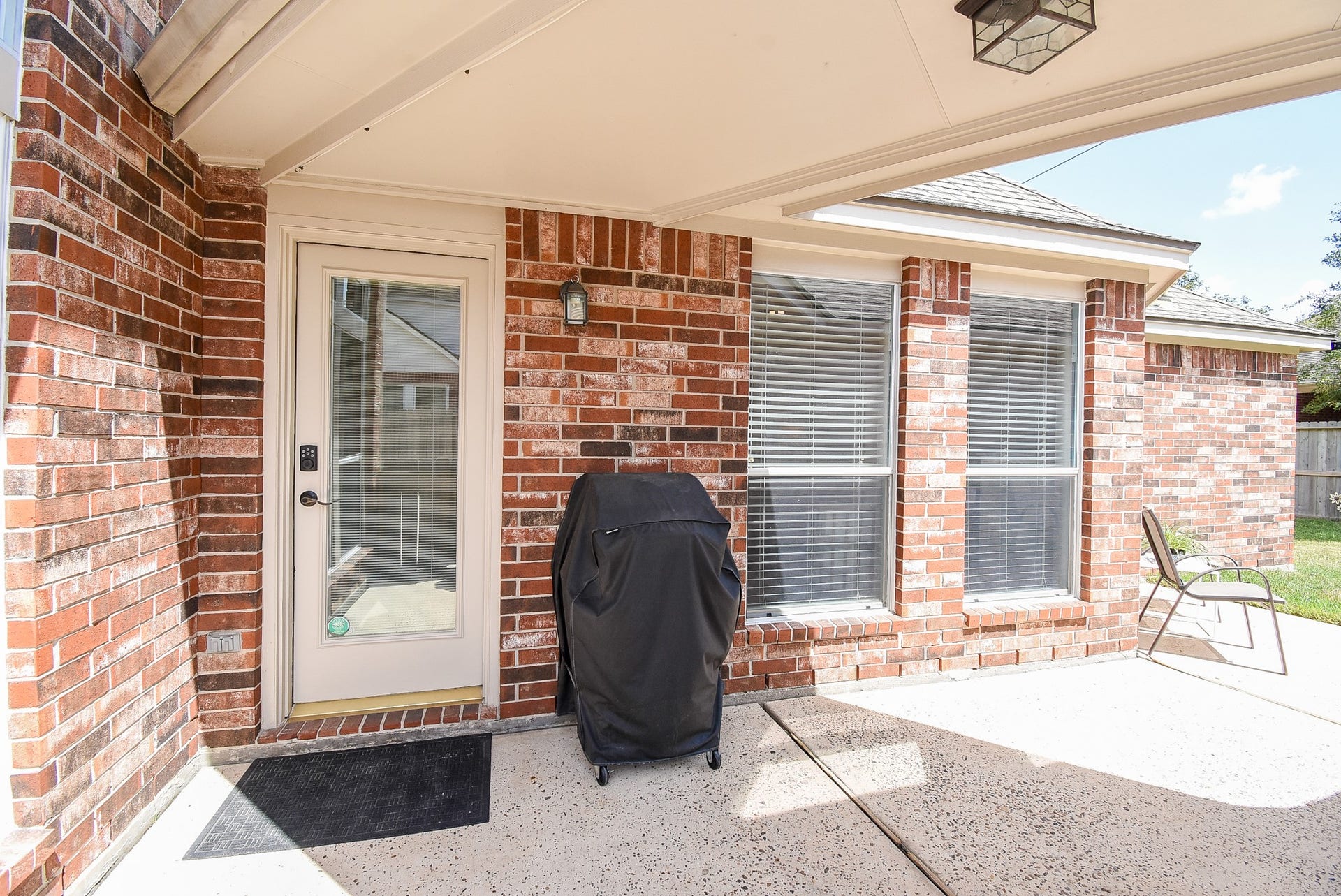 7218 Fall Creek Bend, Humble, TX 77396 Backdoor features covered area to the detached garage.