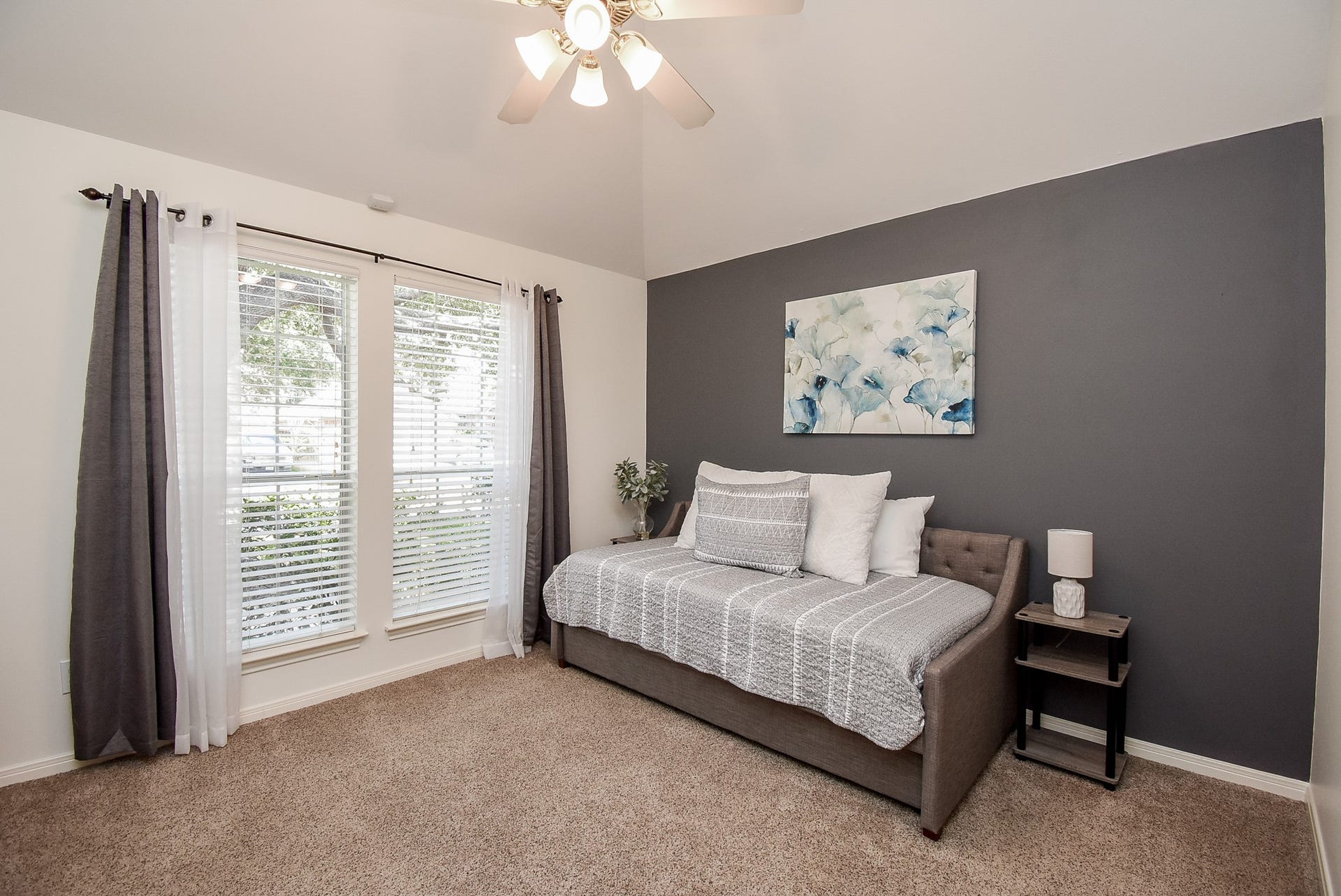 7218 Fall Creek Bend, Humble, TX 77396 Bedroom 2 has a ceiling fan and wall of windows! Great view of the tall shade tree in the front yard!