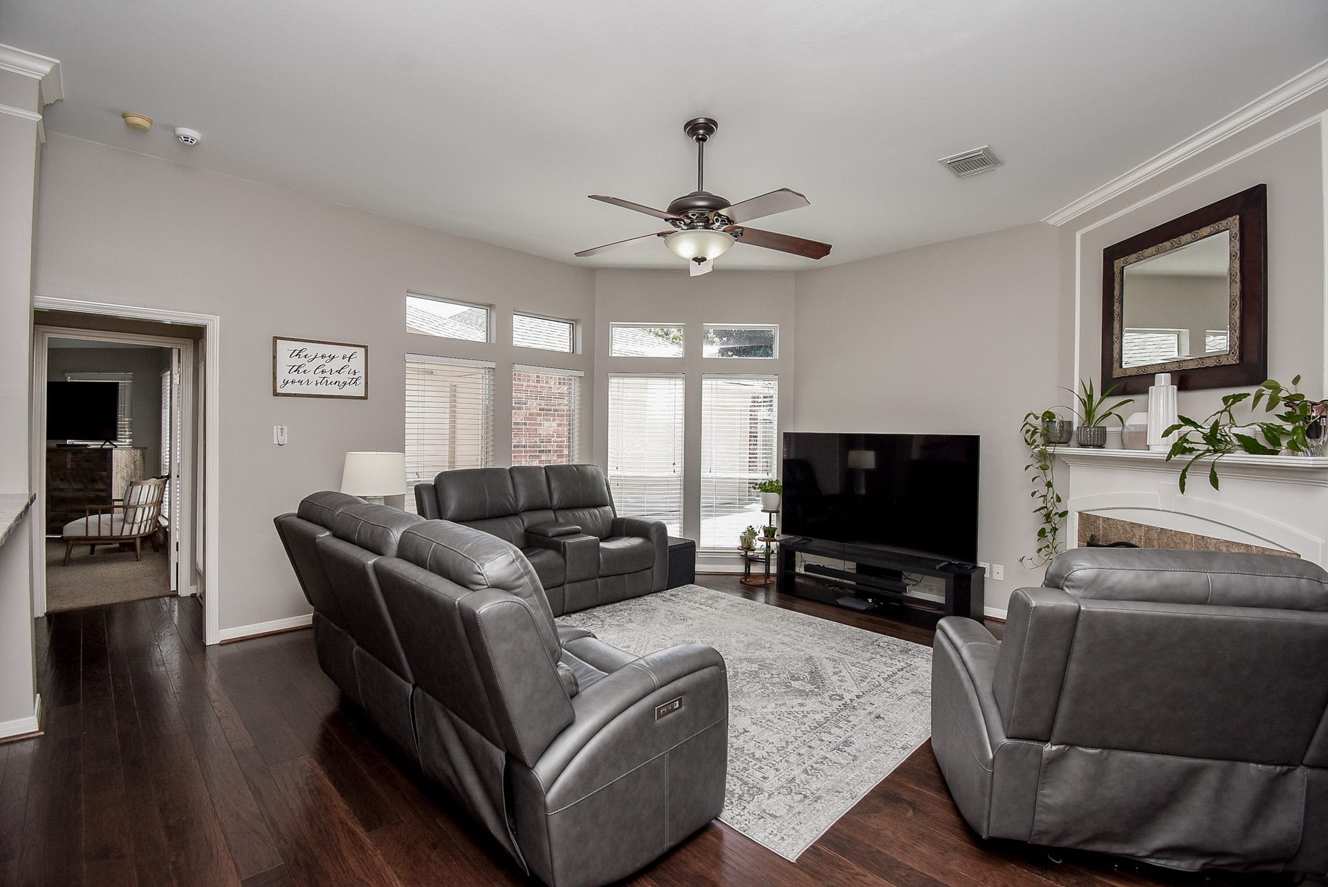 7218 Fall Creek Bend, Humble, TX 77396 The family room has large windows, ceiling fan and a comfortable fireplace.