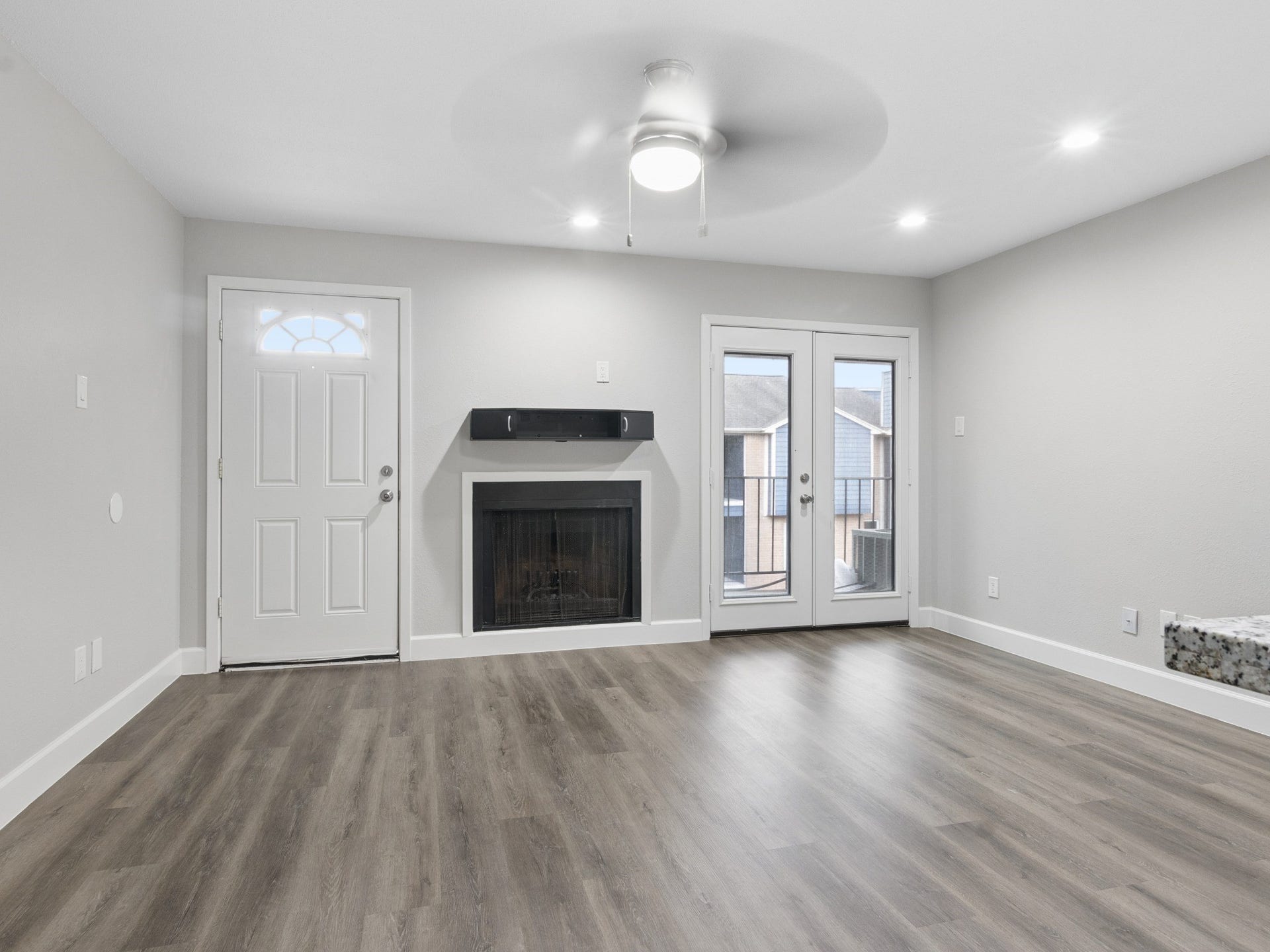 18519 Egret Bay Boulevard, #1906, Webster, TX 77058 Living room with fireplace and balcony.