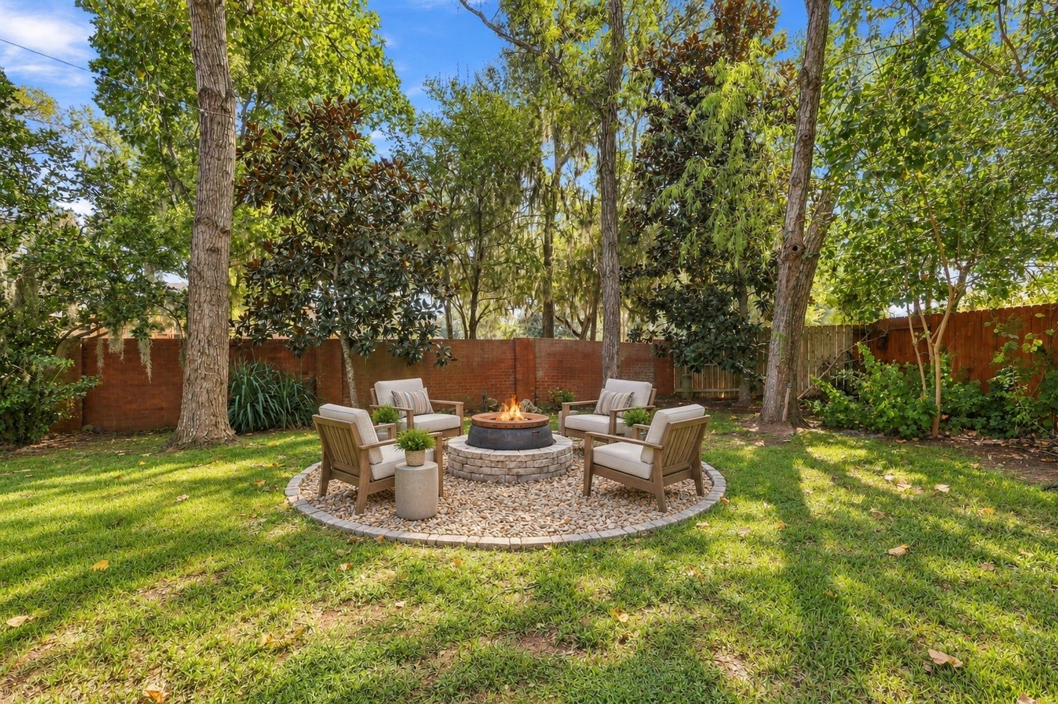 A separate fire pit area provides another destination within the backyard, set beneath mature trees for a more secluded outdoor retreat.**Virtually staged
