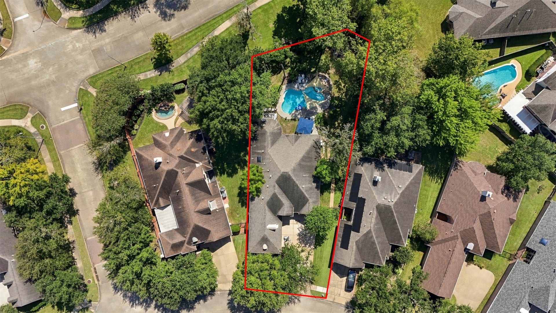 The overhead view clearly defines the propertys footprint and showcases the substantial backyard, private pool, and mature tree coverage.