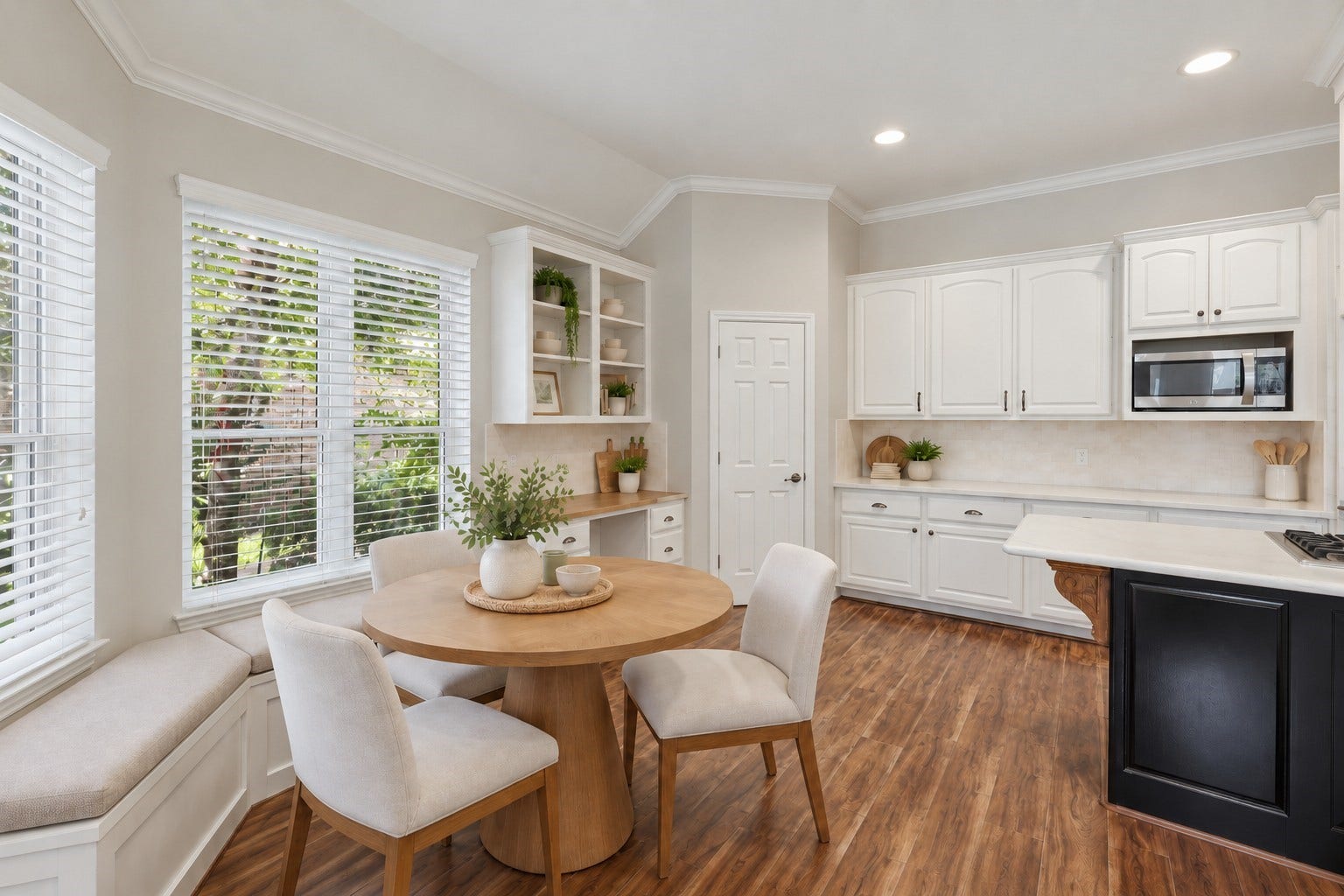 The breakfast area sits beside oversized windows and built-in cabinetry, creating a bright everyday dining space adjacent to the kitchen.**Virtually staged