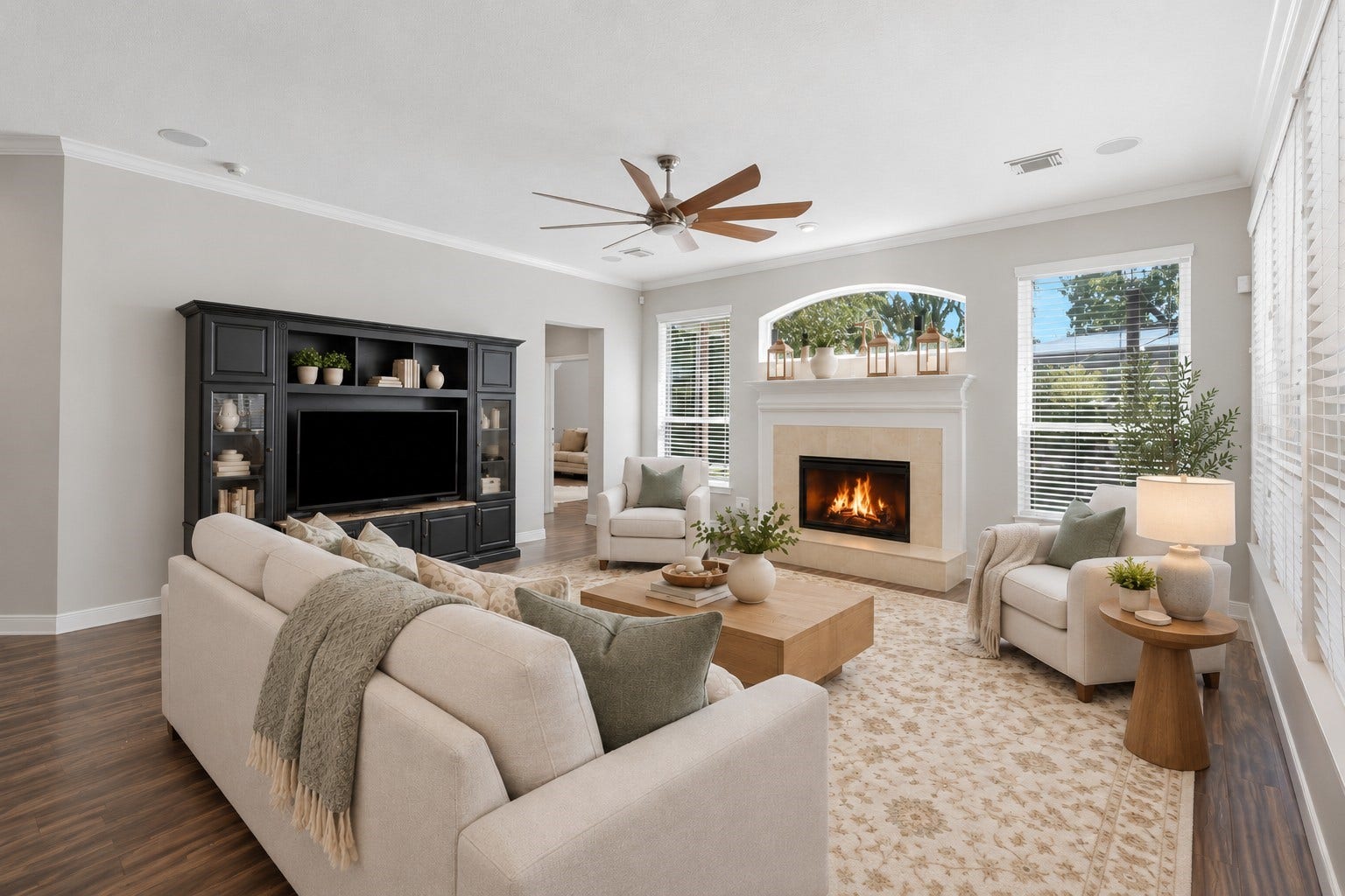 The fireplace creates a focal point, surrounded by windows and ample space for flexible seating.**Virtually staged
