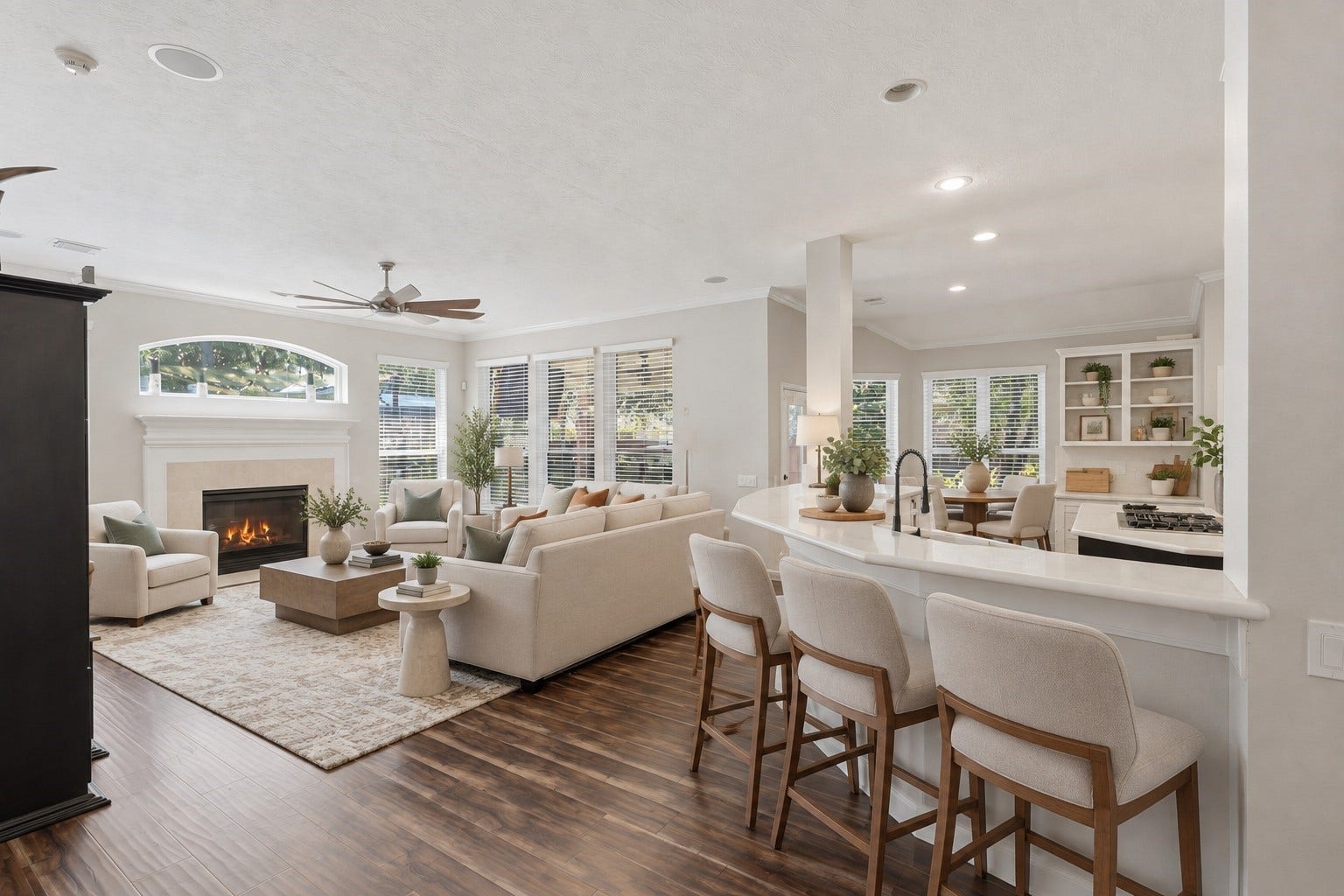 he open-concept layout connects the living room and kitchen, with a breakfast bar, generous windows, and a fireplace anchoring the main gathering space.**Virtually staged