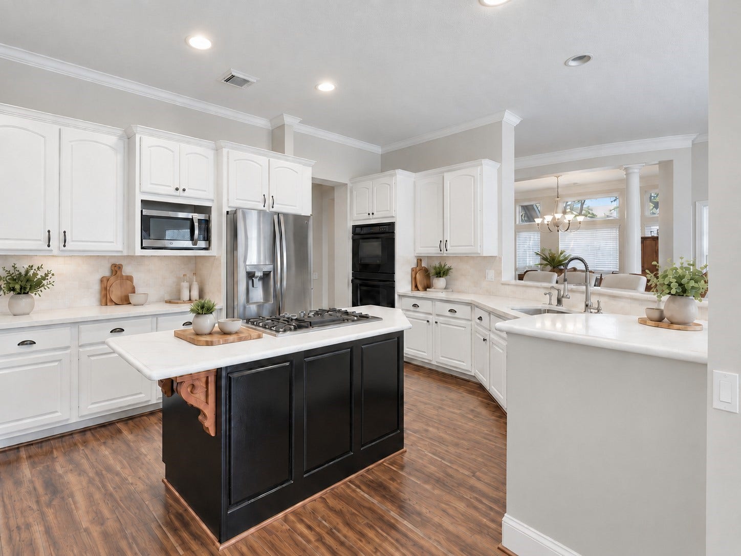 This angle highlights the kitchens functional work zones, double electric oven, breakfast bar, and open connection to the surrounding living and dining areas.**Virtually staged