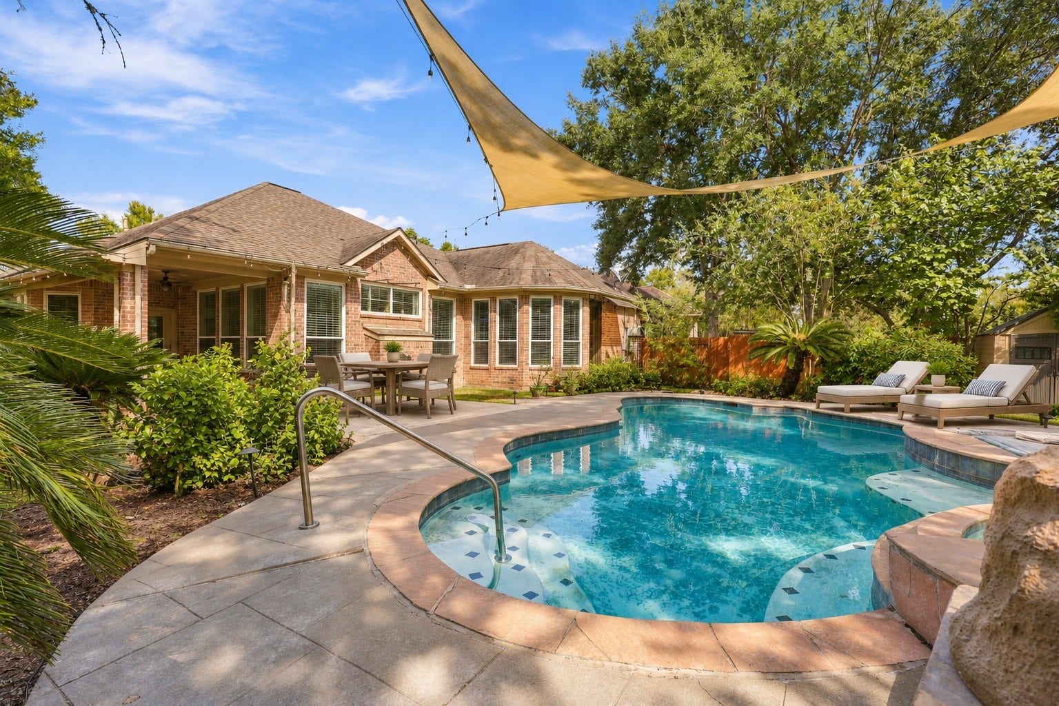 A beautifully designed pool area is framed by mature greenery and ample deck space, creating a private setting for relaxing or entertaining.**Virtually staged