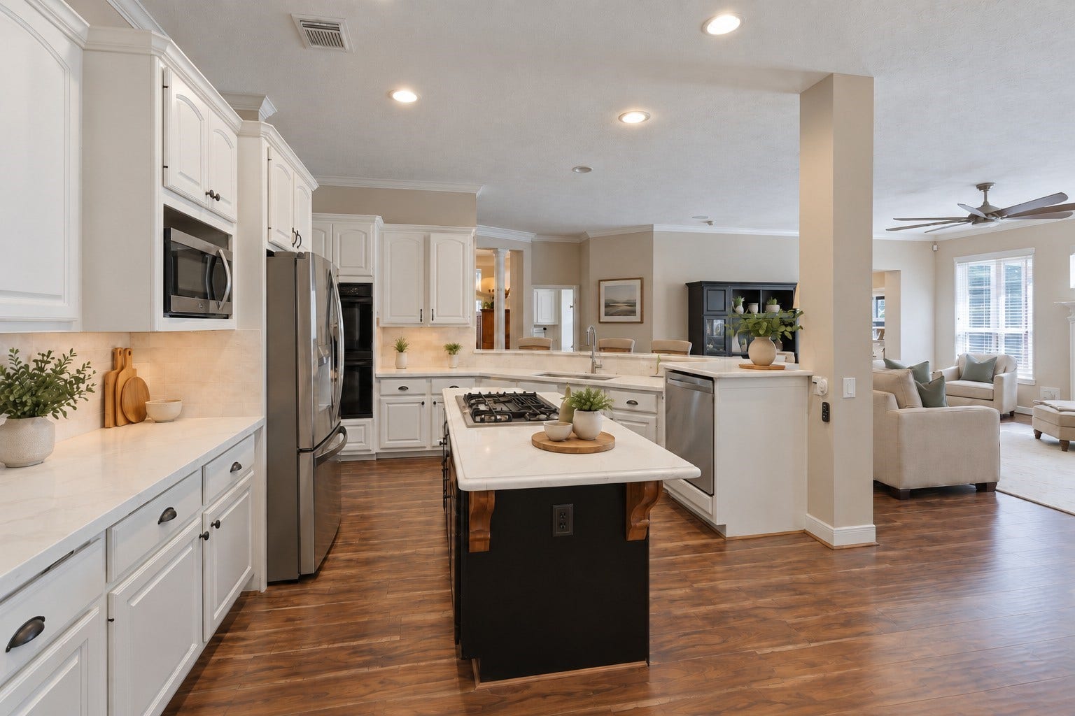 The kitchen offers extensive white cabinetry, generous counter space, stainless steel appliances, and a center island with gas cooktop.**Virtually staged