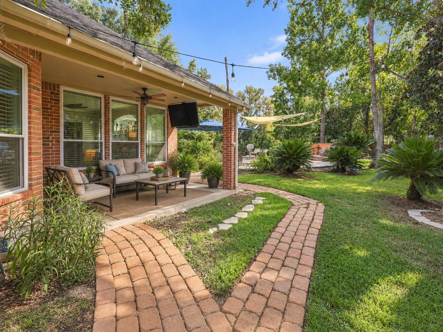 The covered patio extends the living space outdoors and provides direct access to the landscaped backyard and pool area.**Virtually staged