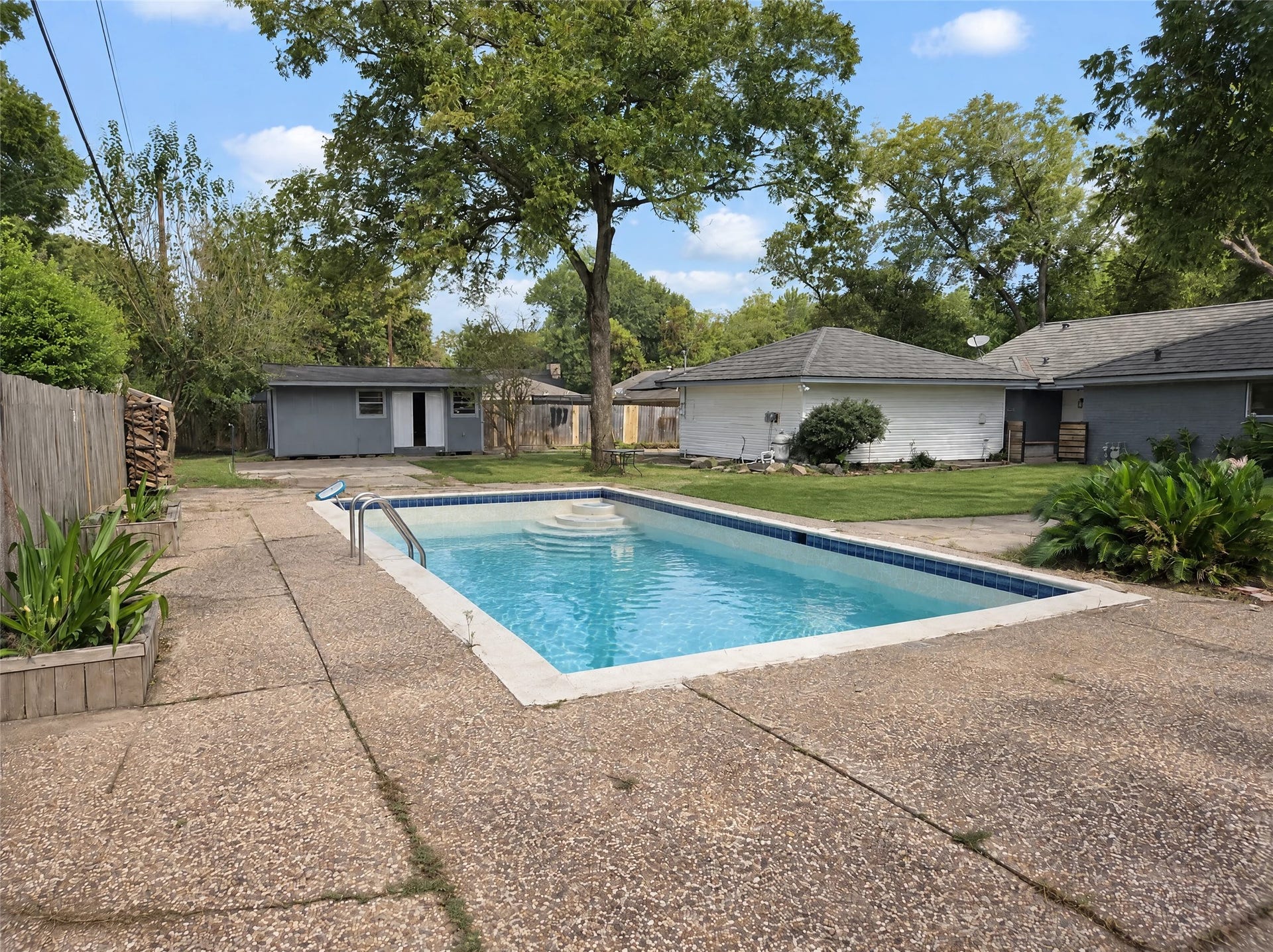 16411 Amcreek Road, Houston, TX 77068 Surrounded by an expansive patio deck, lush lawn, mature trees, and privacy fencing, this space is built for weekend barbecues and summer relaxation.