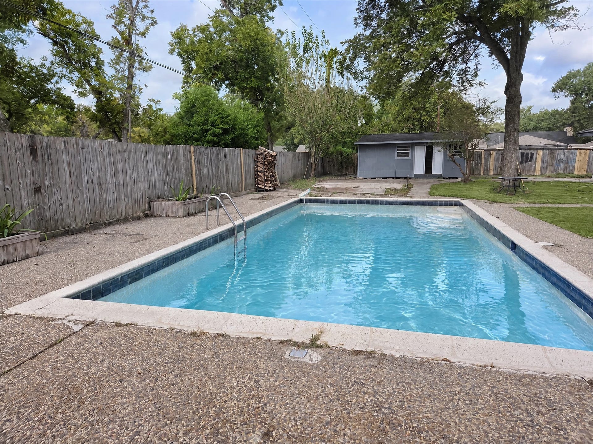 16411 Amcreek Road, Houston, TX 77068 Step outside into your personal paradise featuring an in-ground swimming pool with walk-in entry steps and classic waterline tile.