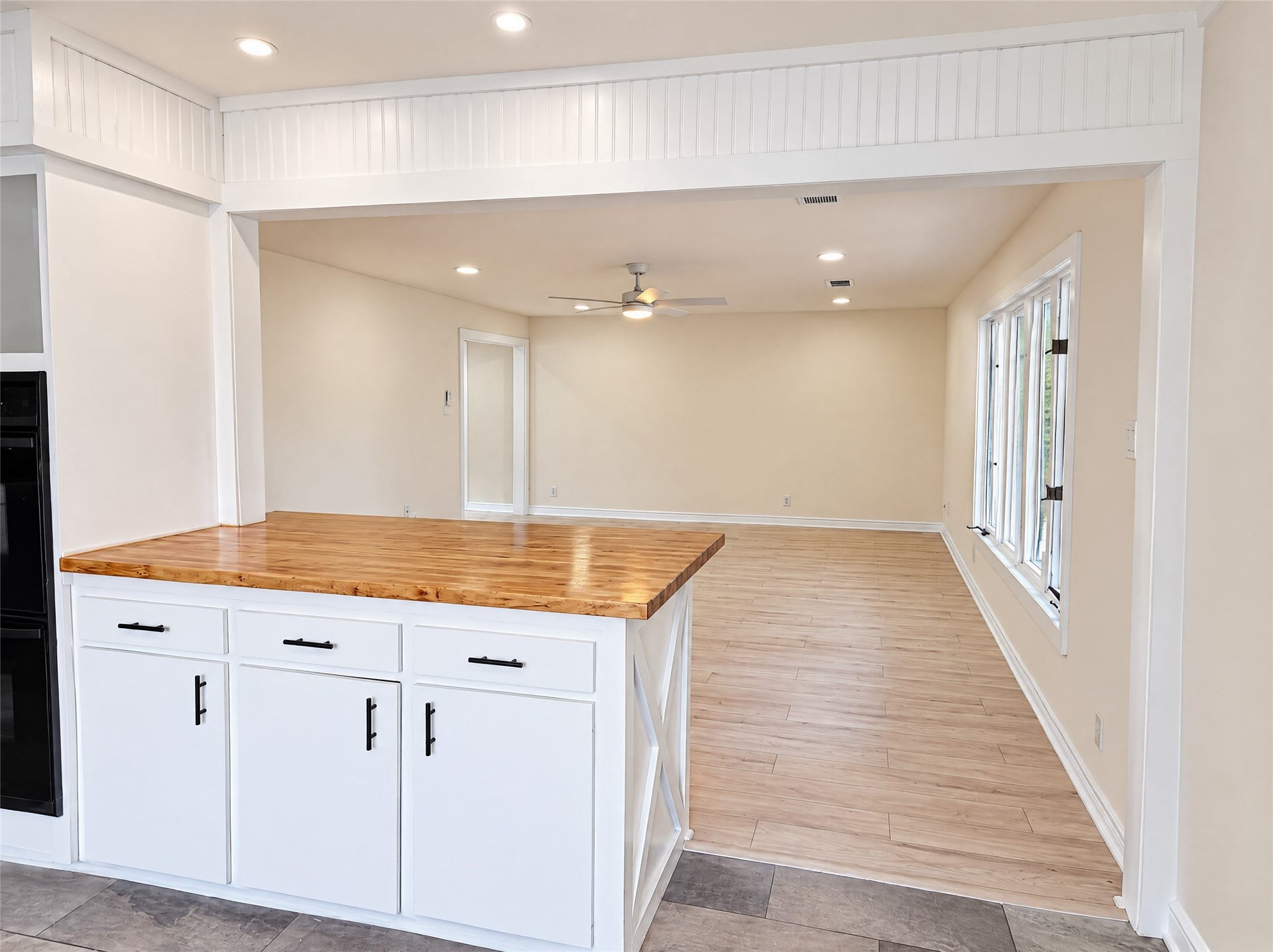 16411 Amcreek Road, Houston, TX 77068 The open layout effortlessly bridges the living room and kitchen. The peninsula island with warm butcher block countertops provides convenient barstool seating and keeps conversation flowing between the cook and guests.
