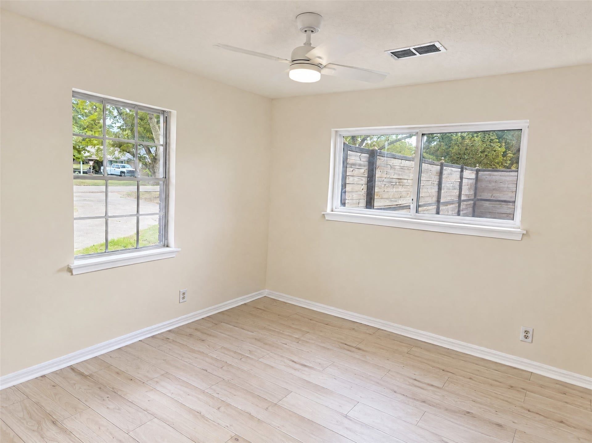16411 Amcreek Road, Houston, TX 77068 Generously sized with dual windows that welcome plenty of natural breeze and light, this bedroom is complete with durable wood-look flooring, neutral paint, and an updated ceiling fanideal for family, guests, or a dedicated home office.