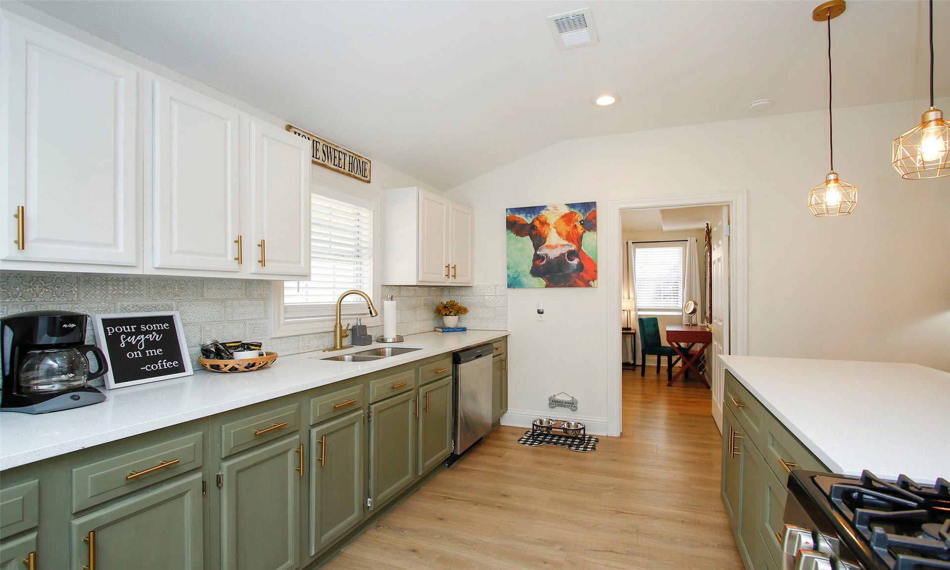 1518 Sabine Street, Houston, TX 77007 Light and bright two-toned modern kitchen with new fixtures. Plenty of cabinet space for storage.