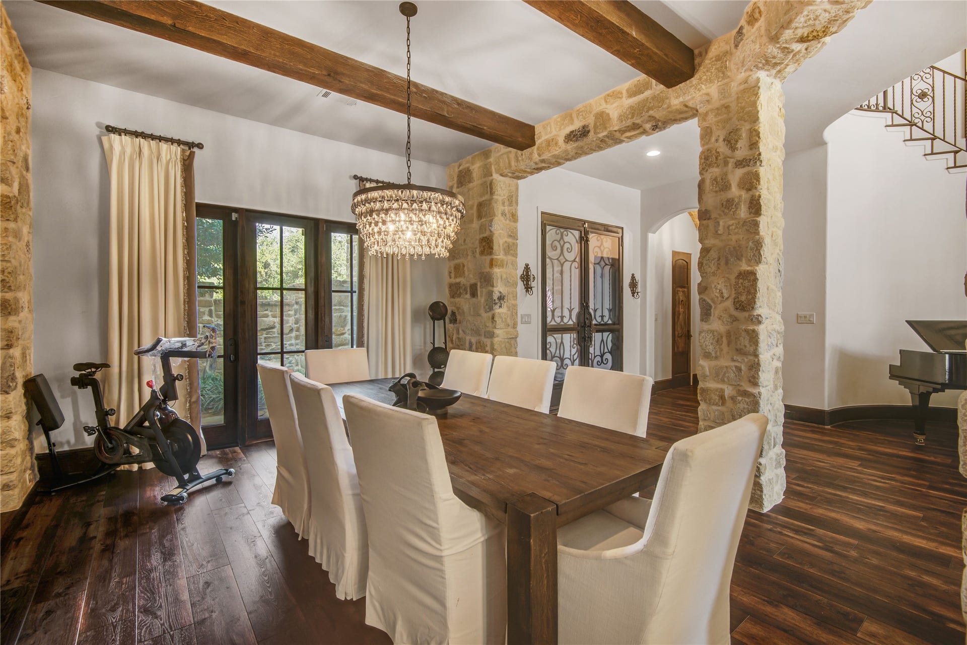 10 Sullivans Lane, Missouri City, TX 77459 Inviting dining area features rustic stone accents and exposed wooden beams. Large windows provide natural light.