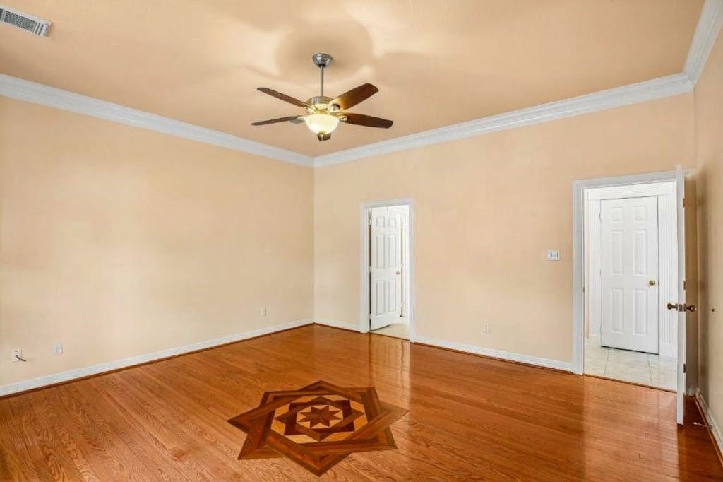 Primary room also features wood flooring and exquisite design detail.