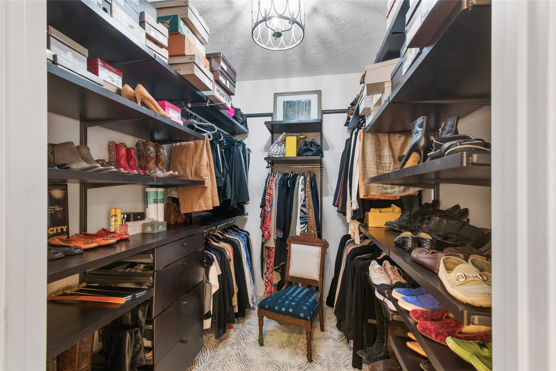 901 Longmire Road, #51, Conroe, TX 77304 Two side by Sige Spacious walk-in closets with ample shelving and hanging space for organizing clothing and accessories, complemented by elegant lighting.