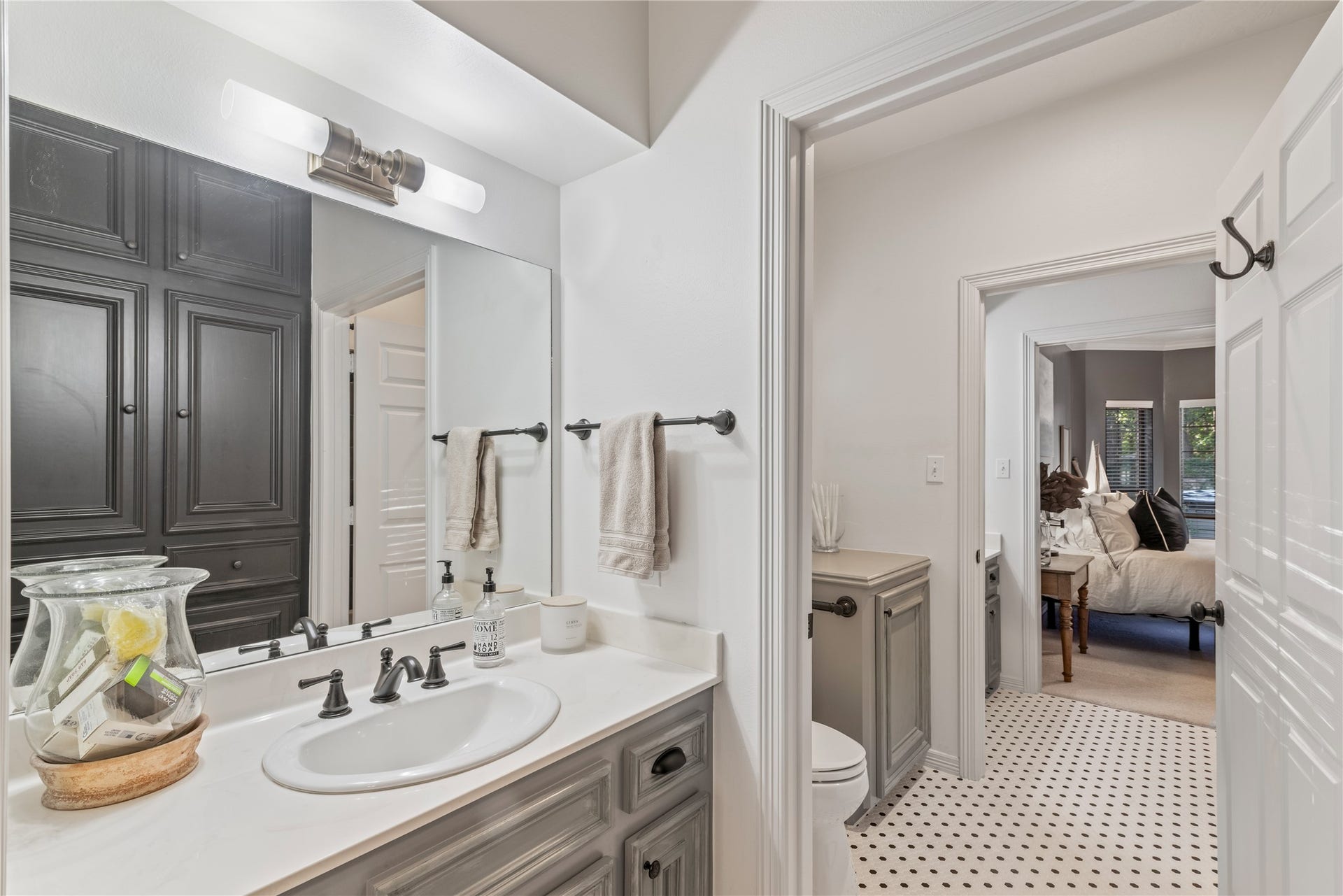 901 Longmire Road, #51, Conroe, TX 77304 Charming bathroom featuring elegant cabinetry, modern fixtures, and a seamless flow into a cozy, inviting bedroom.