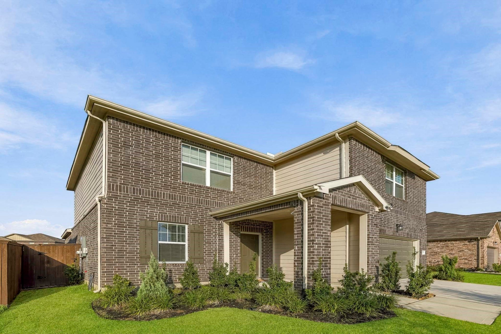 21547 Rolling Streams Drive, New Caney, TX 77357 Lush green lawns, neatly maintained landscaping, and thoughtfully placed landscape lighting enhance the property's charm. The combination of elegant exterior finishes, and mature greenery creates a picture-perfect first impression.