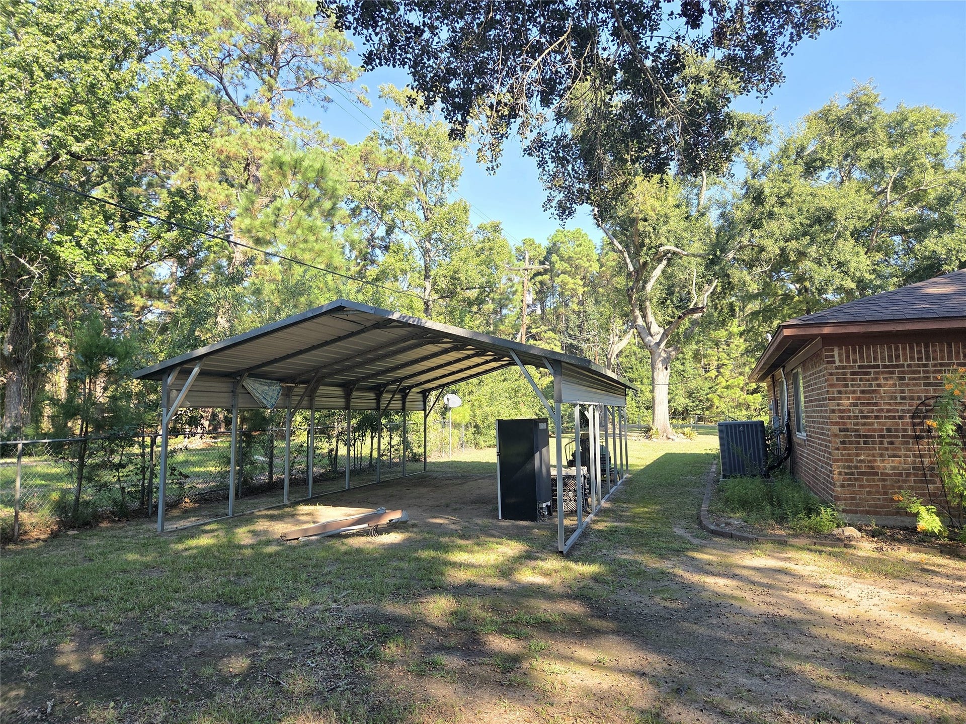 10094 Stidham Road, Conroe, TX 77302 The other carport, this is right by the house and newer HVAC!