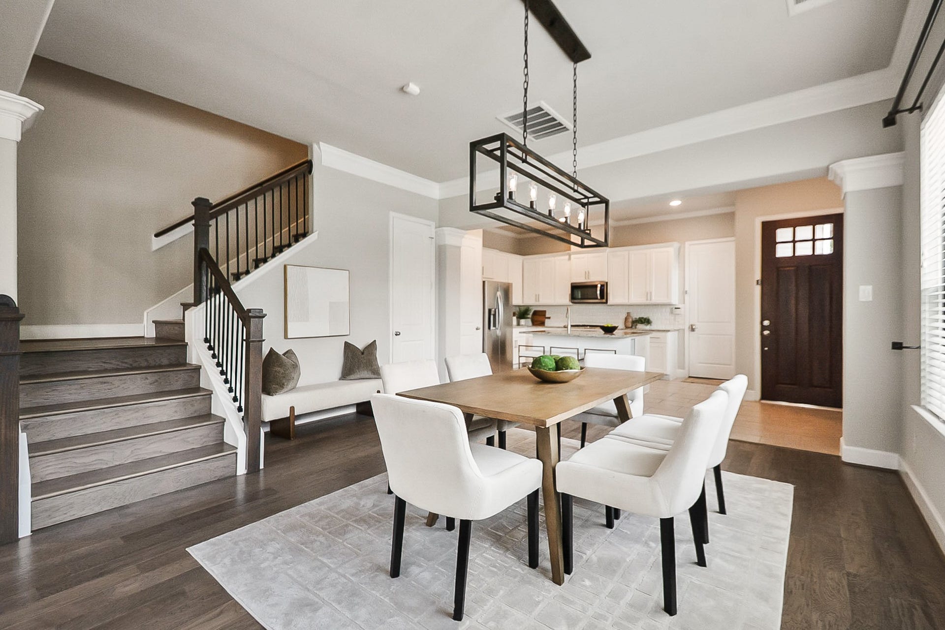 The natural wood tones add character and continuity to the homes design, seamlessly connecting the main living spaces with the upper level.