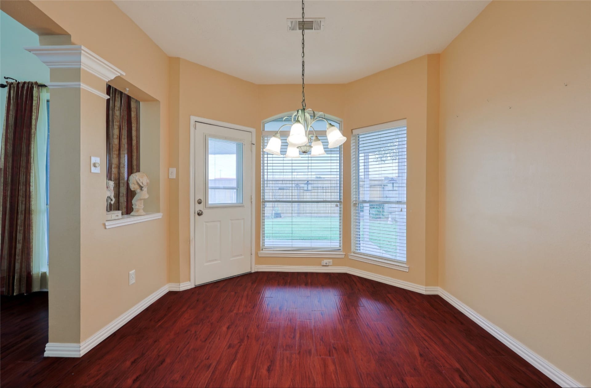 Breakfast rm with door accessing the back covered patio