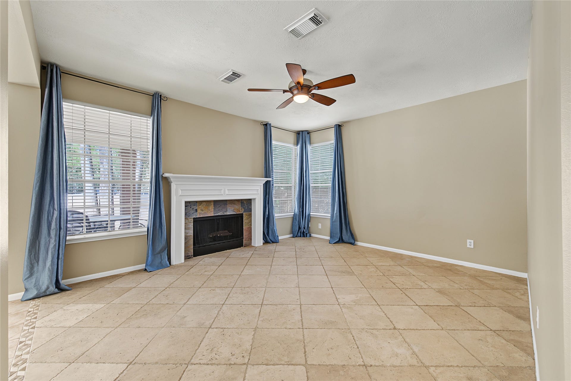 2302 Piney Woods Drive, Pearland, TX 77581 Spacious family room with a fireplace and windows overlooking the backyard