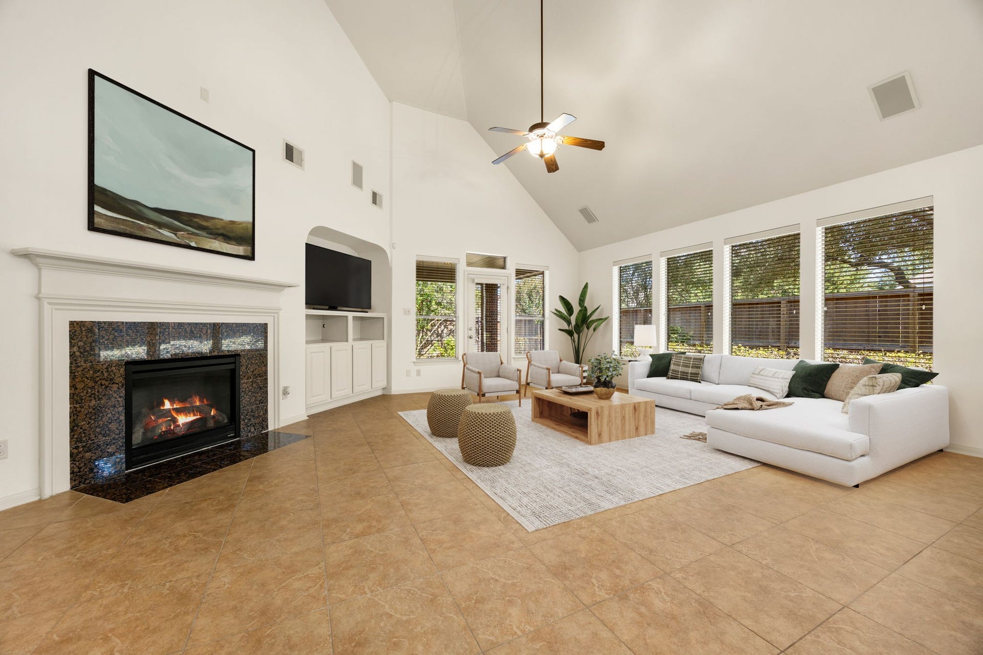 9430 Amethyst Arbor Lane, Katy, TX 77494 A handsome fireplace with a rich, dark granite surround and detailed white mantel serves as the ultimate living room centerpiece, perfectly complemented by a custom built-in entertainment center. *Virtually Staged