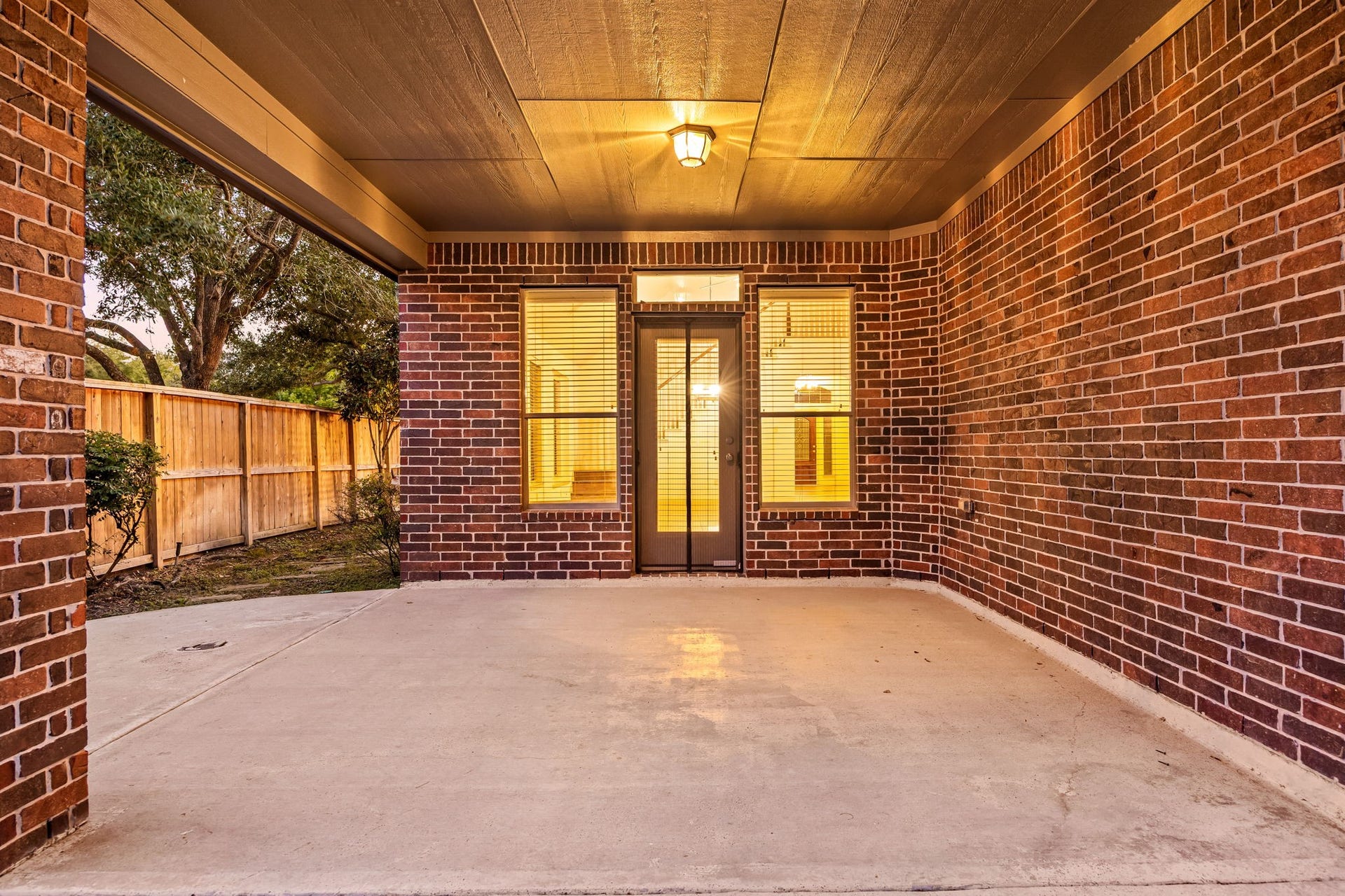 9430 Amethyst Arbor Lane, Katy, TX 77494 This expansive covered patio serves as a fantastic outdoor extension of the home, framed by a handsome, full-brick structural design and a high wood-paneled ceiling.