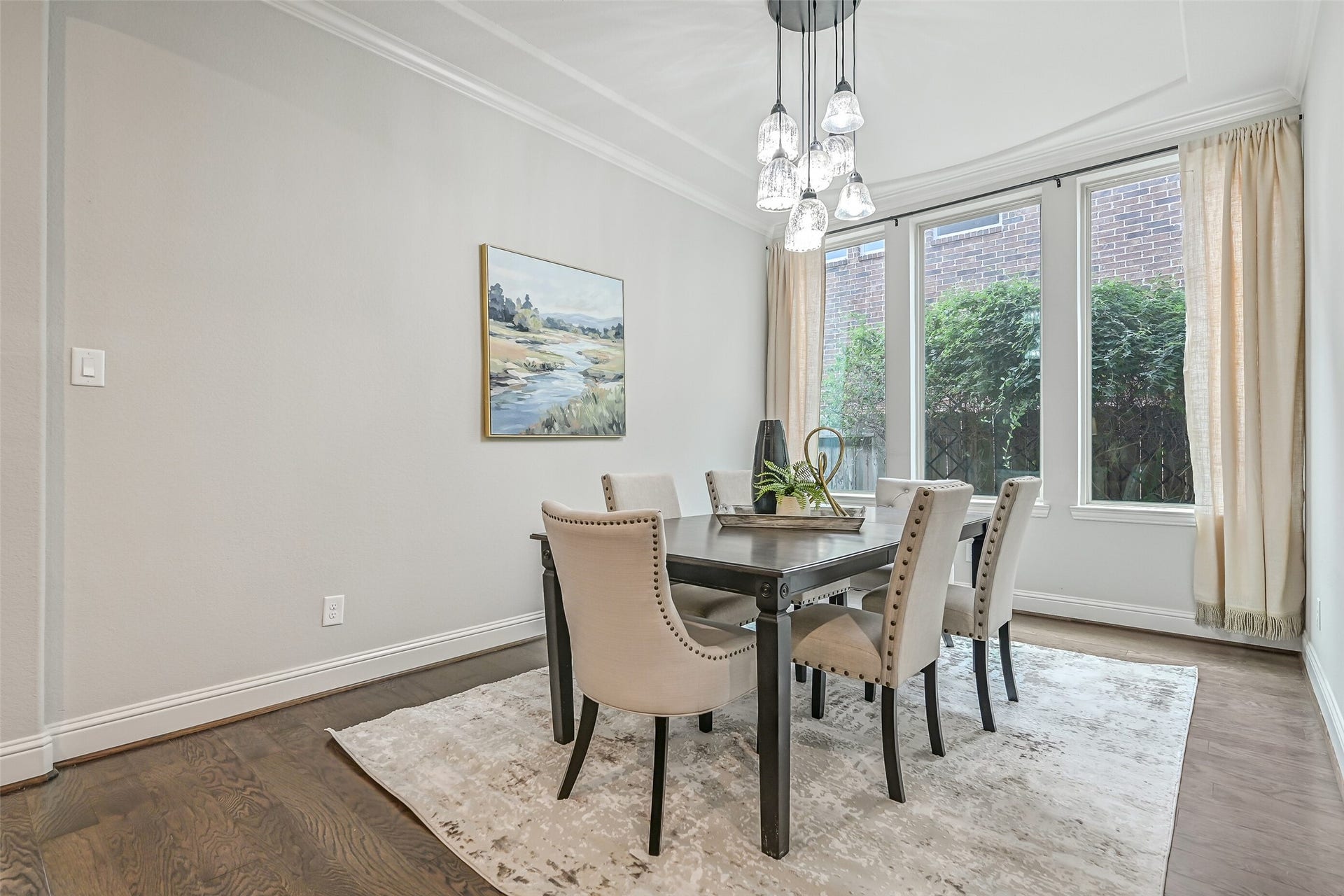1640 Longwood Glen Lane, Friendswood, TX 77546 Just off the foyer, the formal dining room features rich luxury vinyl plank flooring, crown molding, a custom cascading glass chandelier & a trio of windows overlooking the side landscaping. Plenty of room to gather around the table!